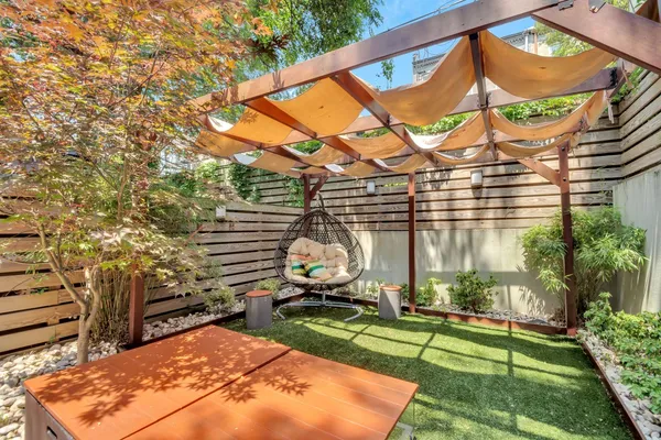 a view of a backyard with couches plants and a backyard