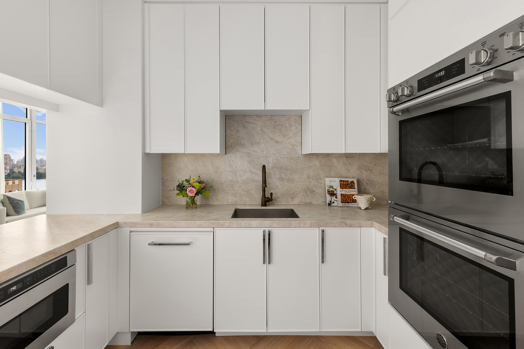 15 West 96th Street, Unit 11 Manhattan, NY 10025 - Photo 5 of 18 a kitchen with white cabinets and appliances