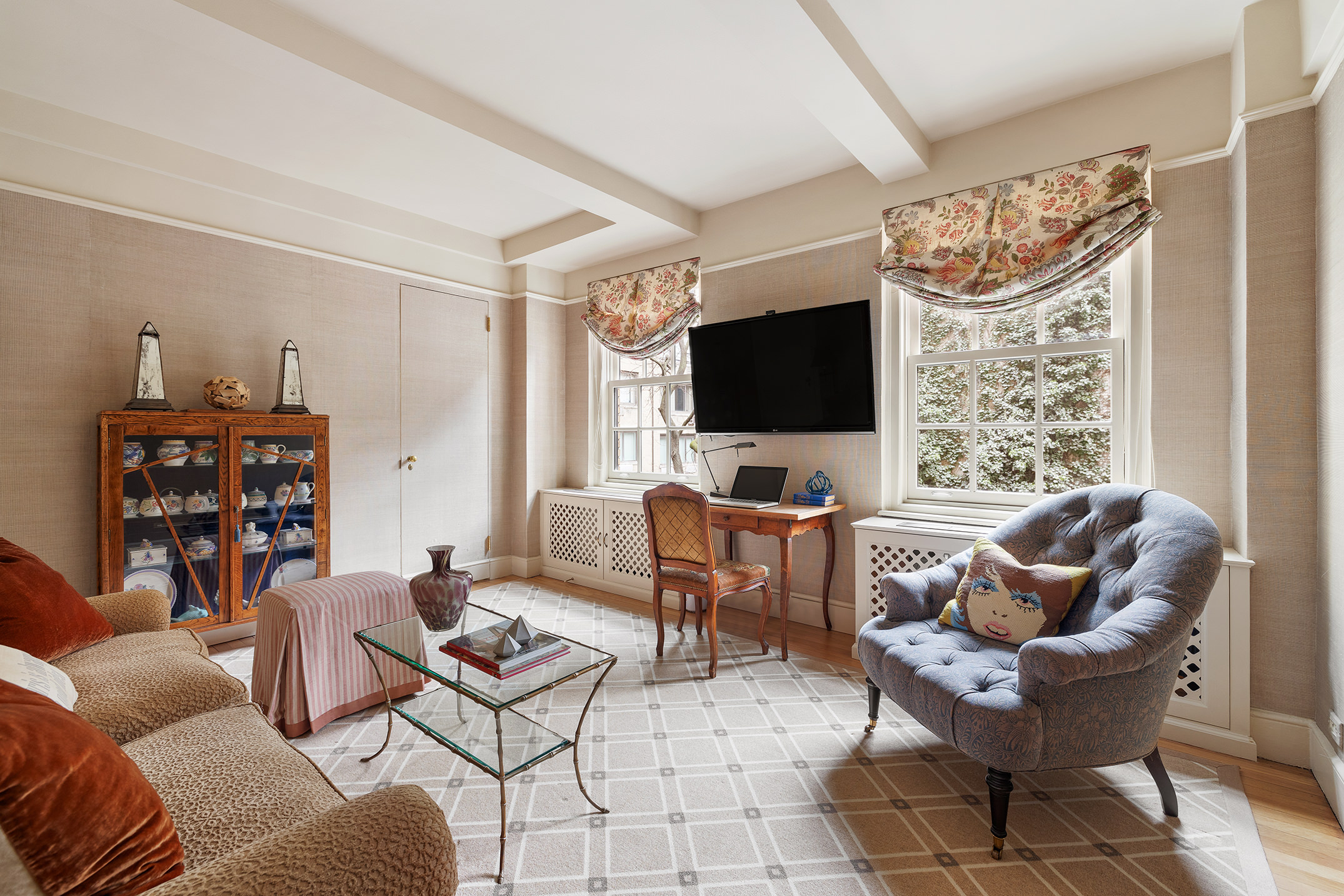 169 East 78th Street, Unit 5D Manhattan, NY 10075 - Photo 6 of 15 a living room with furniture a flat screen tv and a window