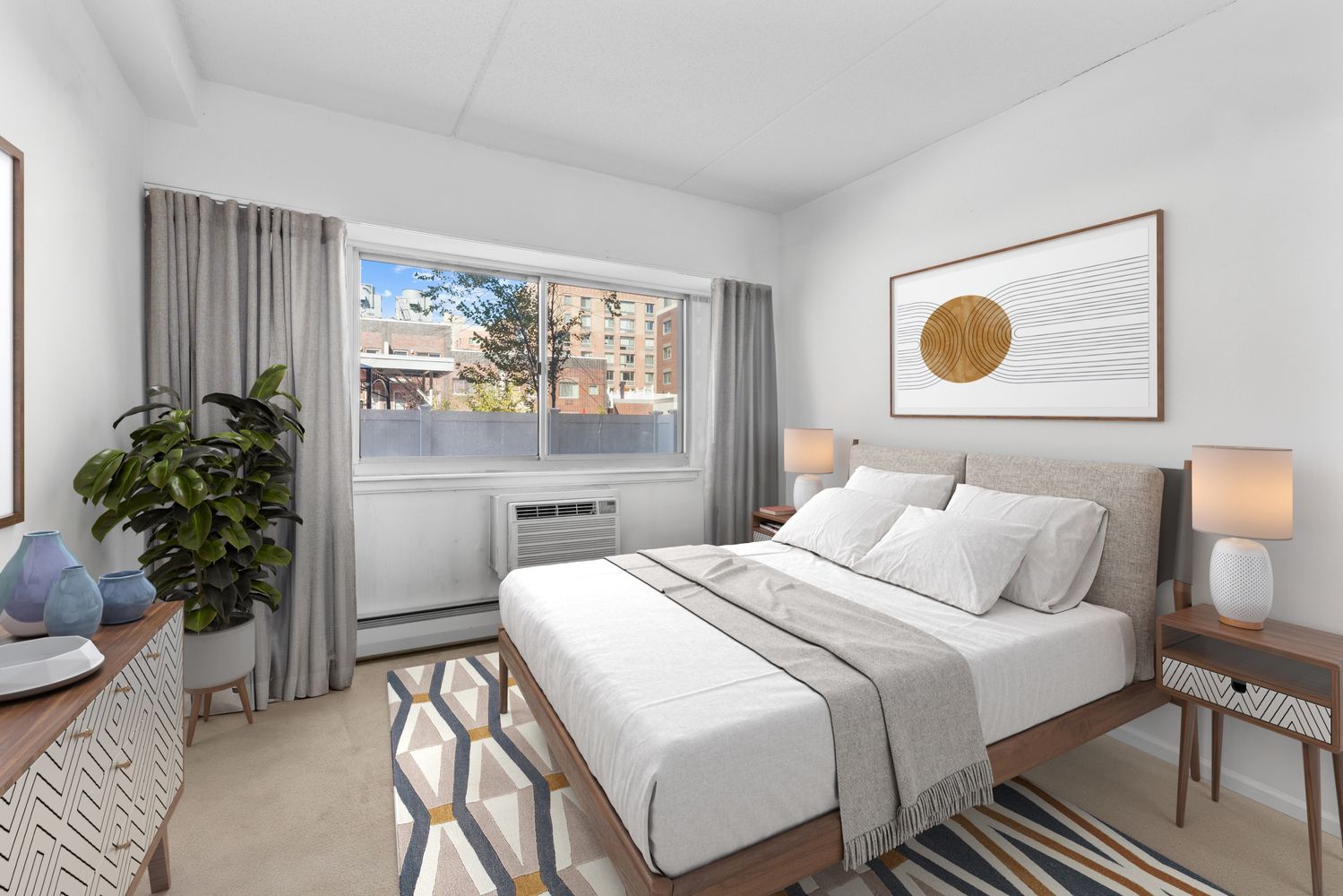 300 West 145th Street, Unit 1QQ Manhattan, NY 10039 - Photo 6 of 15 a bedroom with a bed and a potted plant