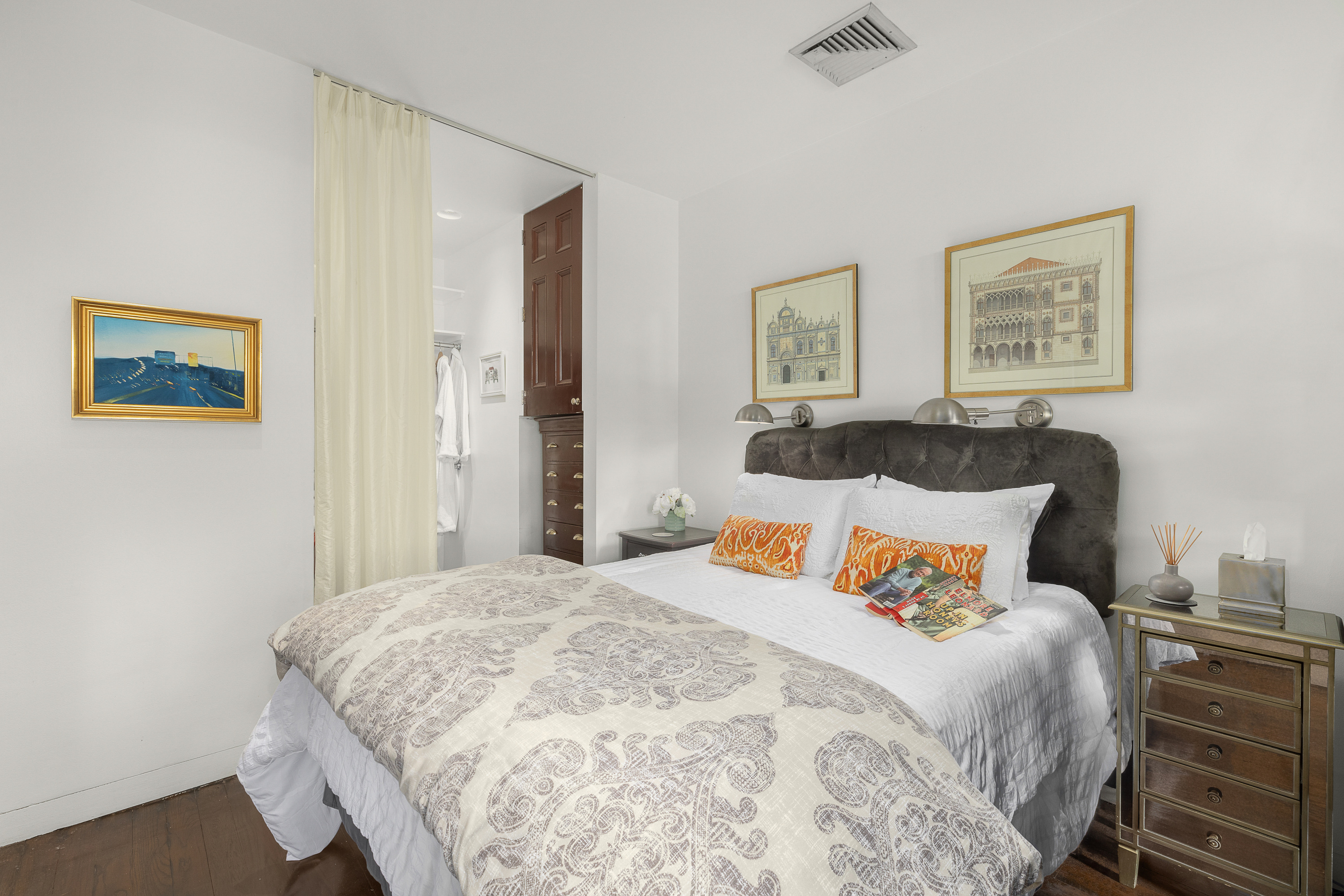 38-06 28th Street, Unit 1 Queens, NY 11101 - Photo 5 of 8 a bedroom with bed and painting on the wall