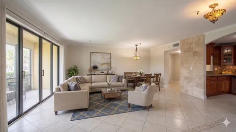 a living room with couches and a dining table with kitchen view