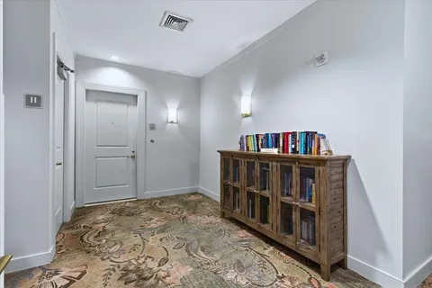 a living room with furniture and potted plant