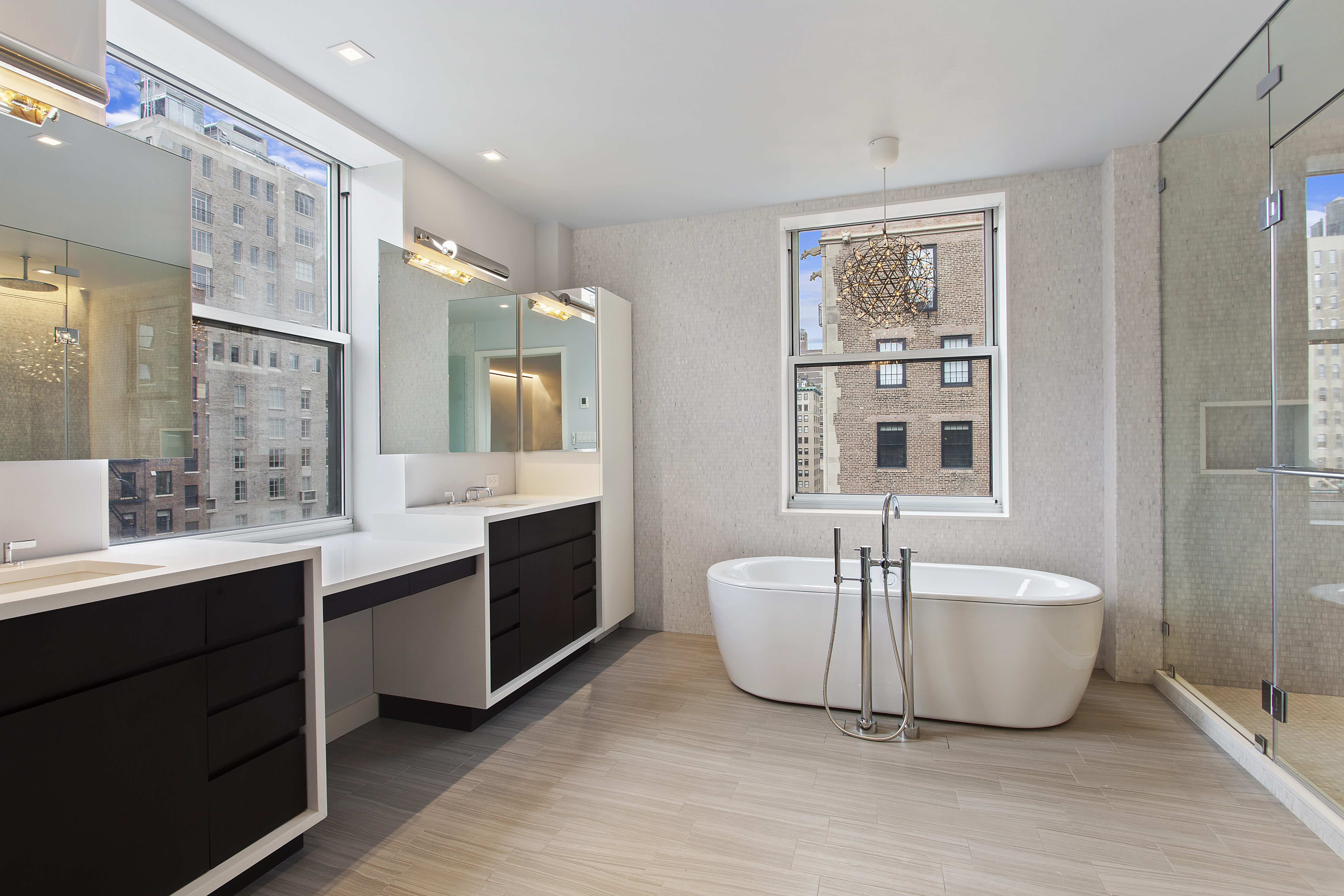 East 80th Street Manhattan, NY 10075 - Photo 7 of 13 a bathroom with a sink double vanity mirror and a bathtub
