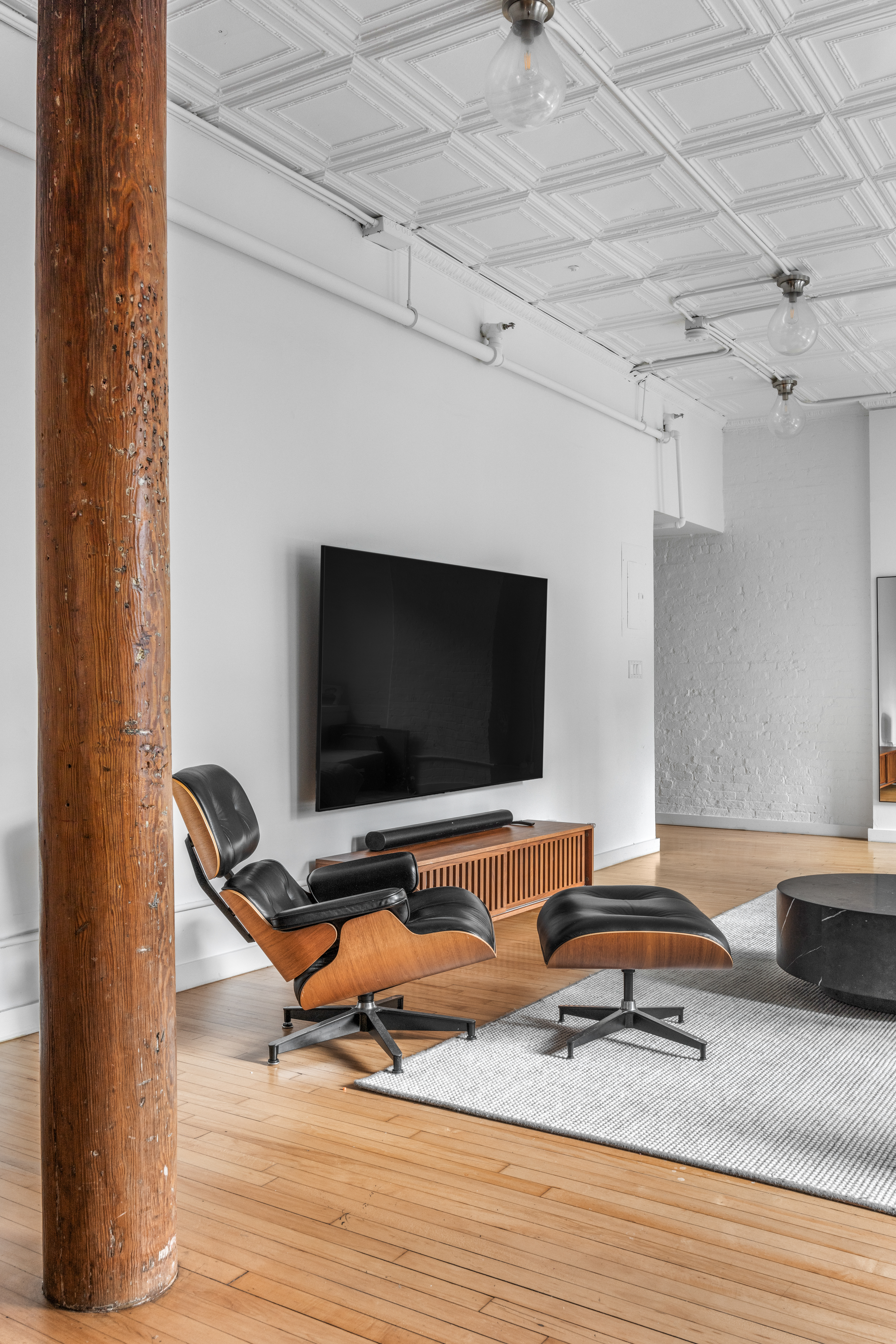 5 White Street, Unit 5B Manhattan, NY 10013 - Photo 19 of 21 a living room with furniture and a flat screen tv