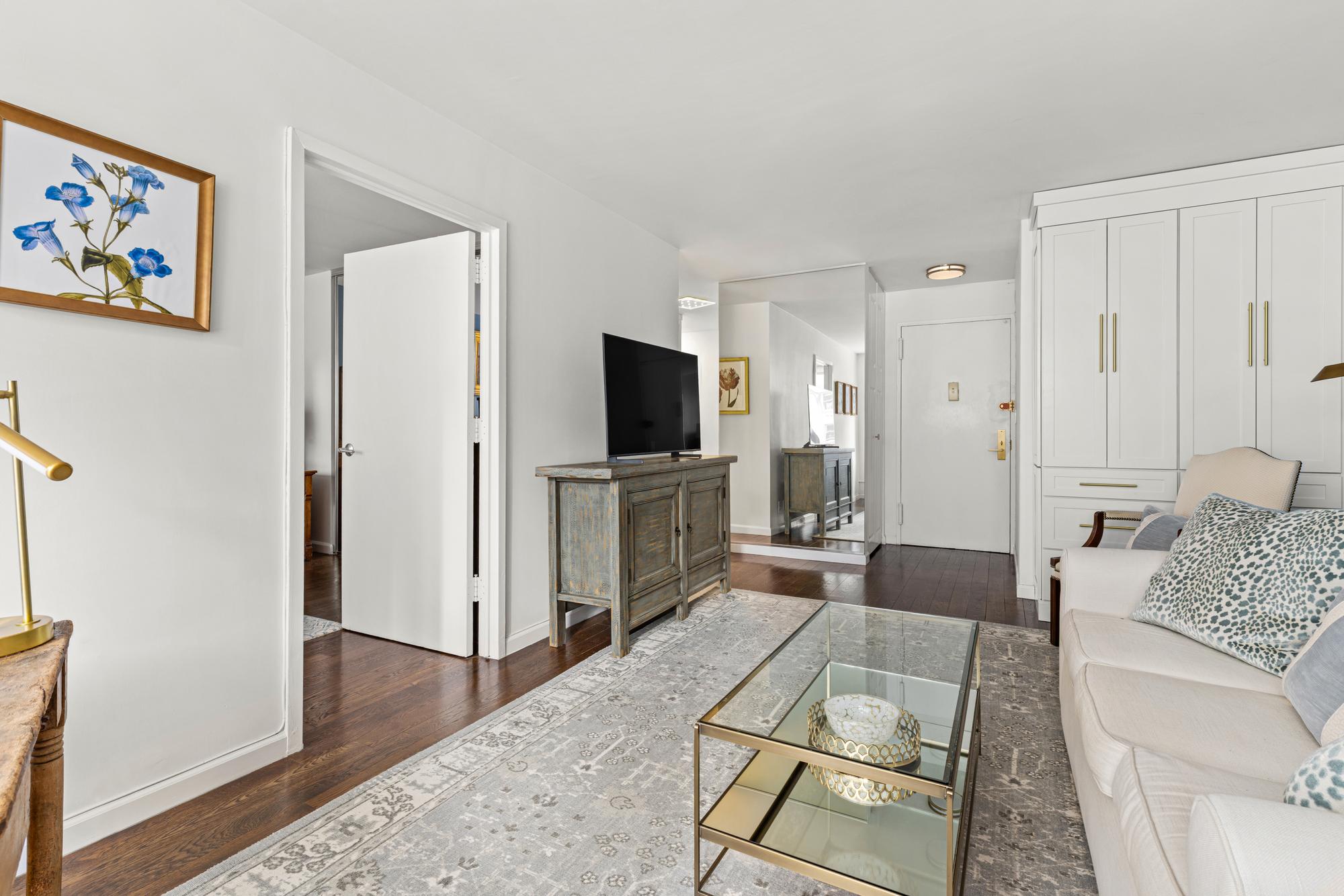 2025 Broadway, Unit 5K Manhattan, NY 10023 - Photo 2 of 15 a living room with furniture and a flat screen tv