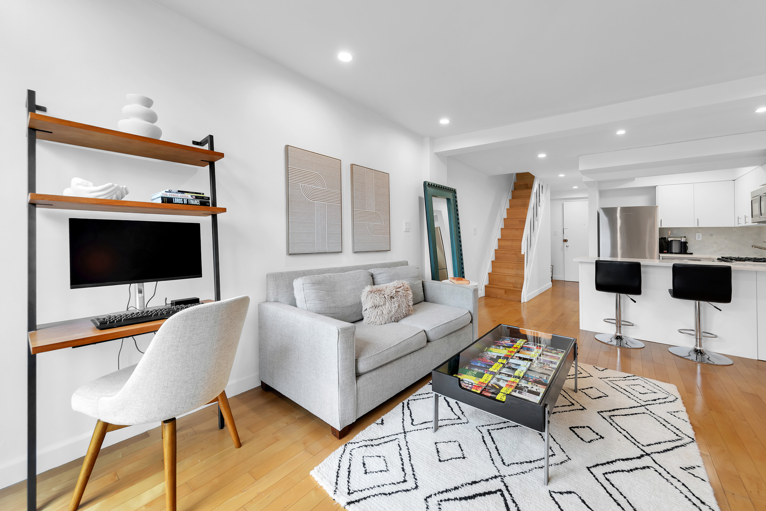 215 East 24th Street, Unit 602 Manhattan, NY 10010 - Photo 3 of 8 a living room with furniture and a flat screen tv