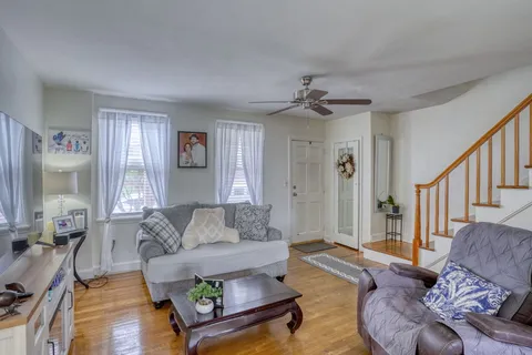 a living room with furniture and a large window