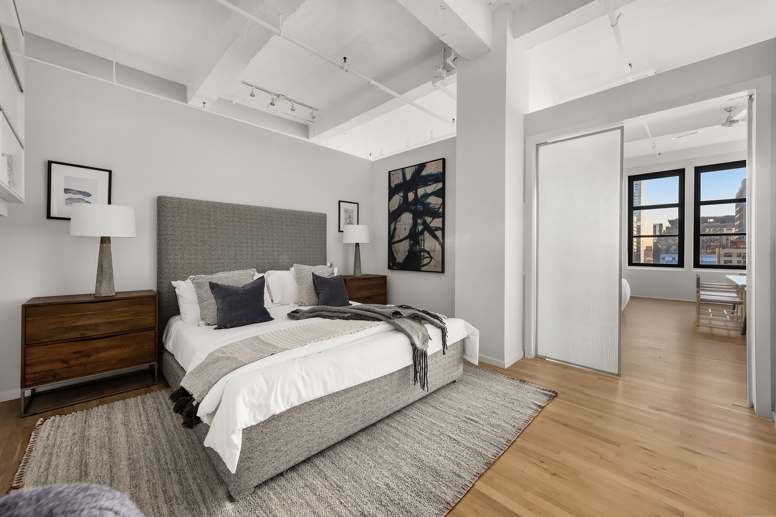 448 West 37th Street, Unit 12F Manhattan, NY 10018 - Photo 7 of 11 a bedroom with bed and a night stand