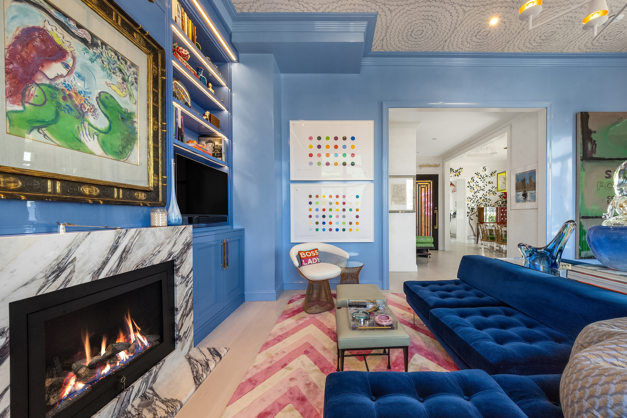 145 East 76th Street, Unit PH Manhattan, NY 10021 - Photo 4 of 19 a living room with furniture and a fireplace