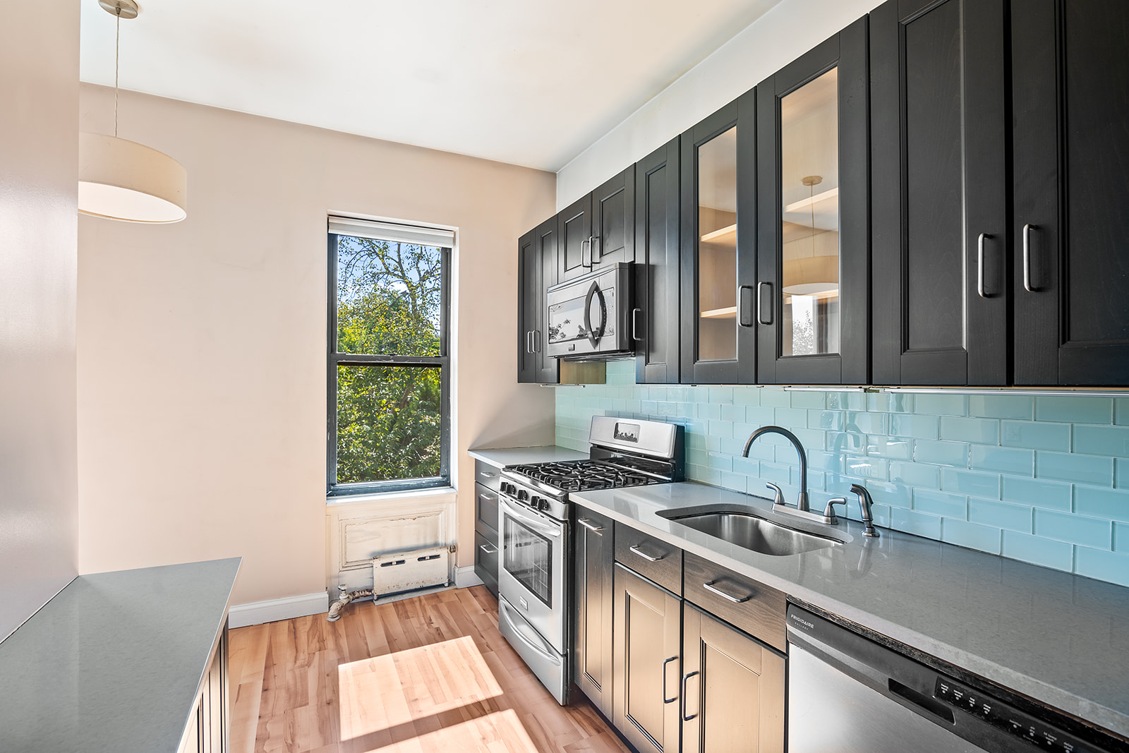 512 17th Street Brooklyn, NY 11215 - Photo 8 of 14 a kitchen that has a sink a stove and a window