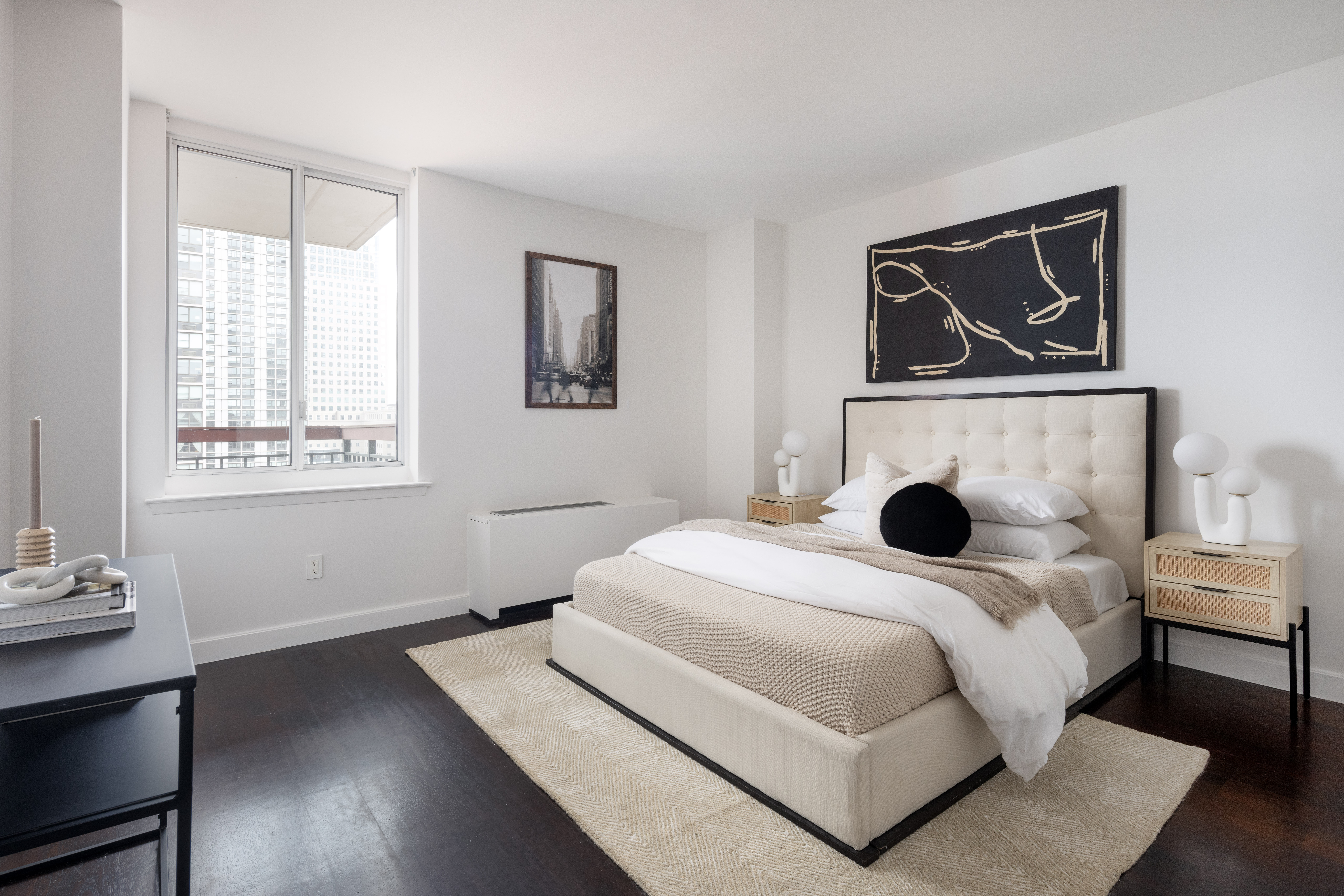 333 Rector Place, Unit 1401 Manhattan, NY 10280 - Photo 4 of 9 a bedroom with a bed and a window