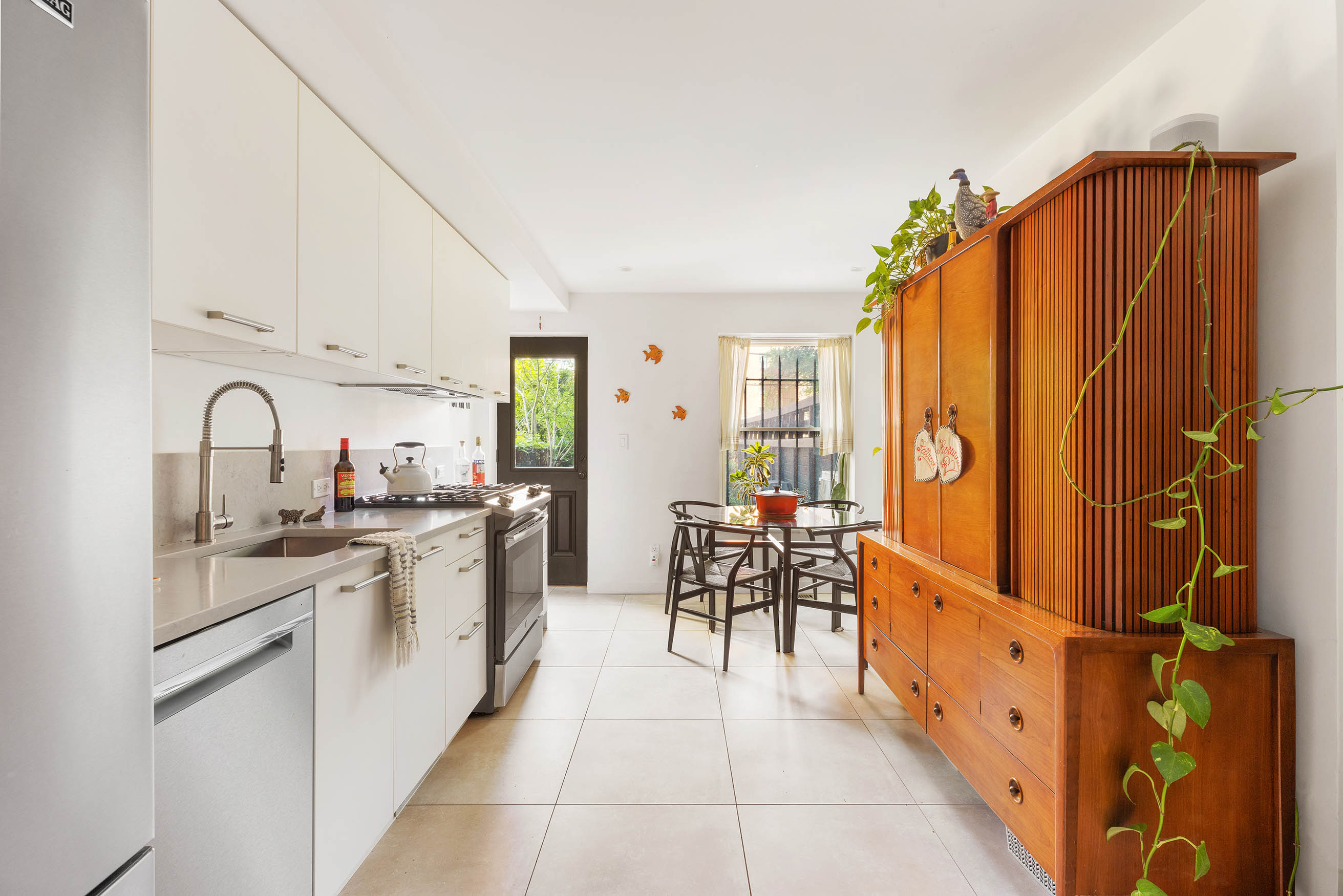 379 Monroe Street Brooklyn, NY 11221 - Photo 7 of 15 a kitchen with stainless steel appliances a sink and cabinets