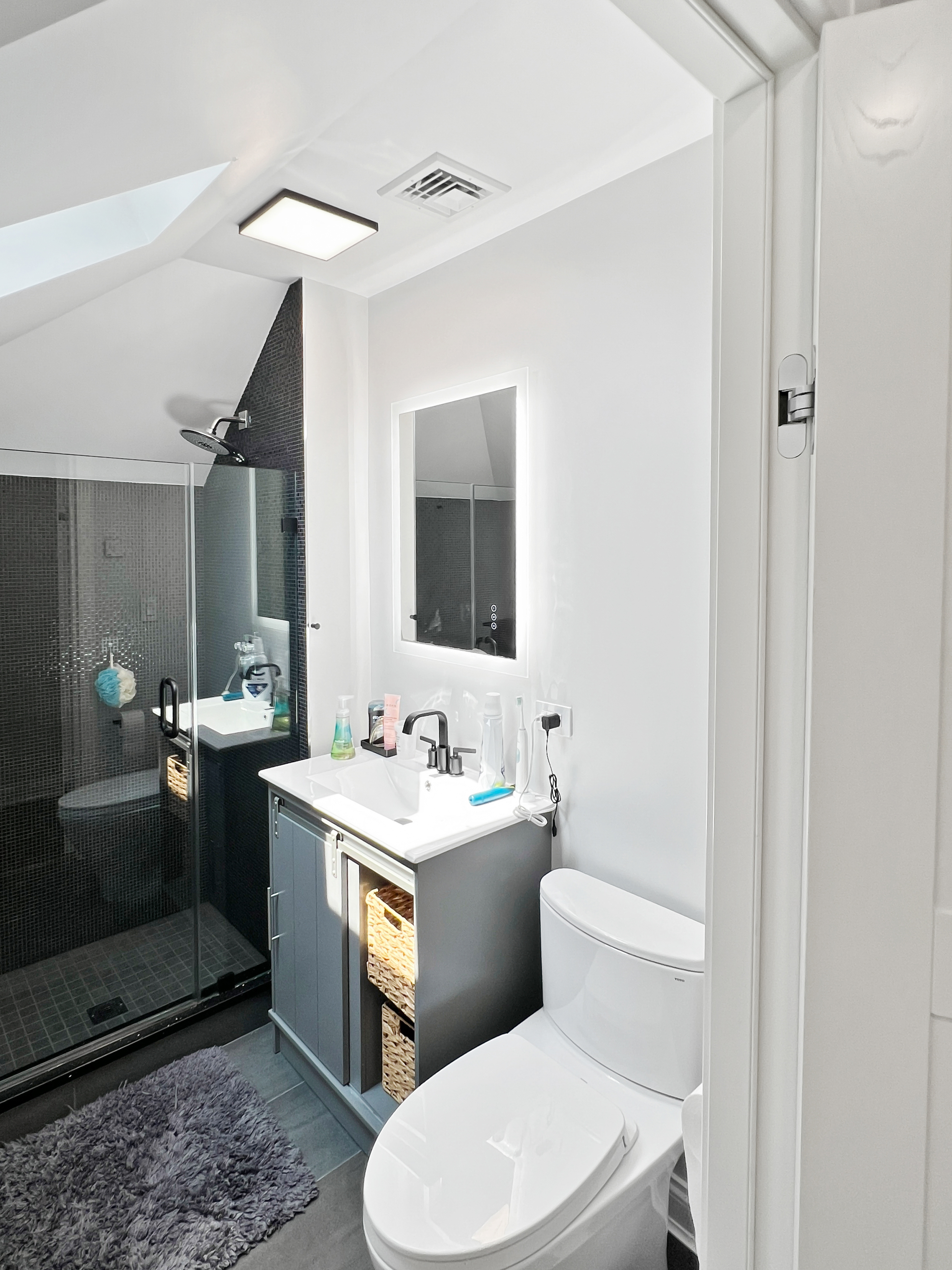 5021 Surf Avenue Brooklyn, NY 11224 - Photo 20 of 32 a bathroom with a toilet sink and mirror