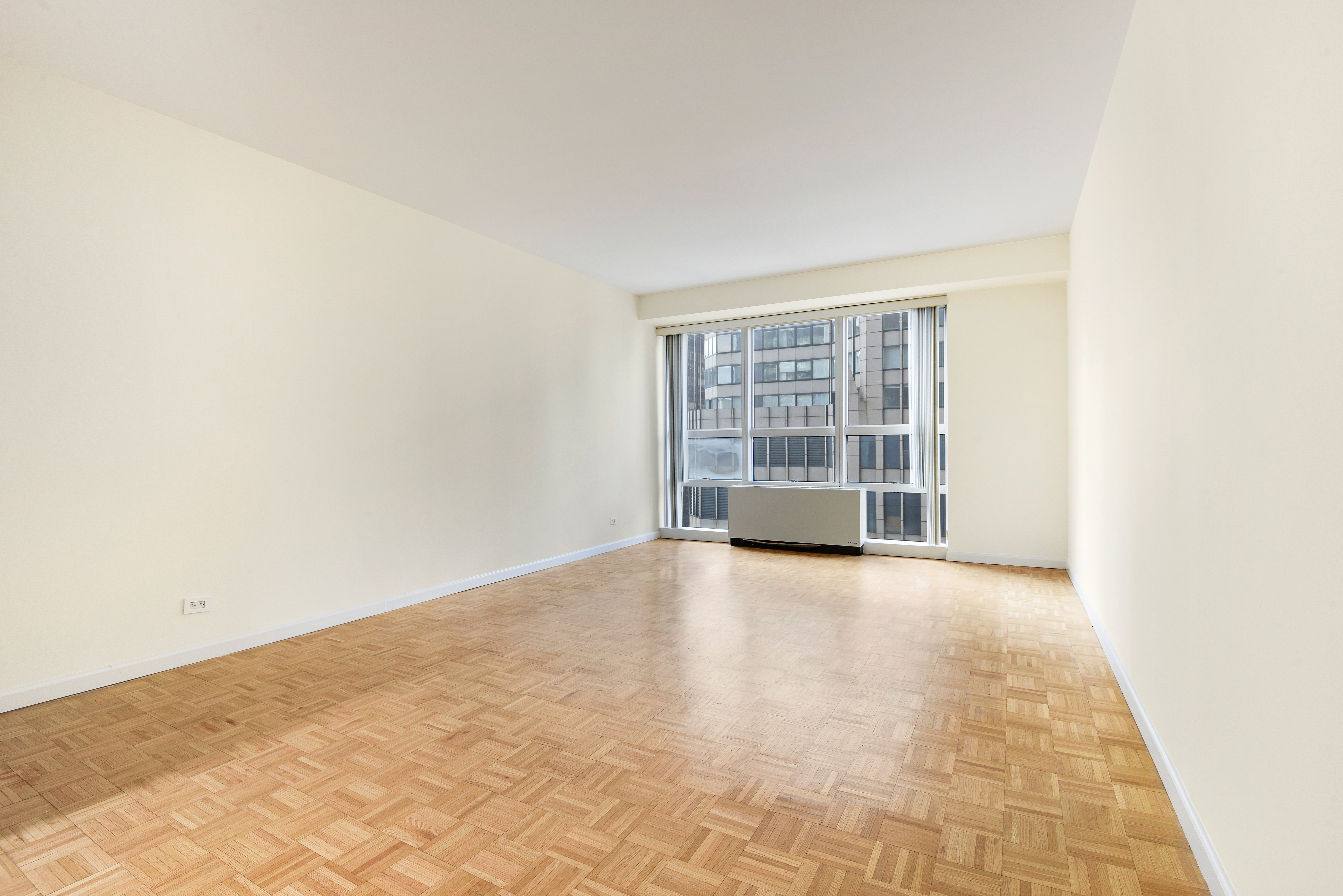 146 West 57th Street, Unit 38E Manhattan, NY 10019 - Photo 9 of 16 an empty room with windows