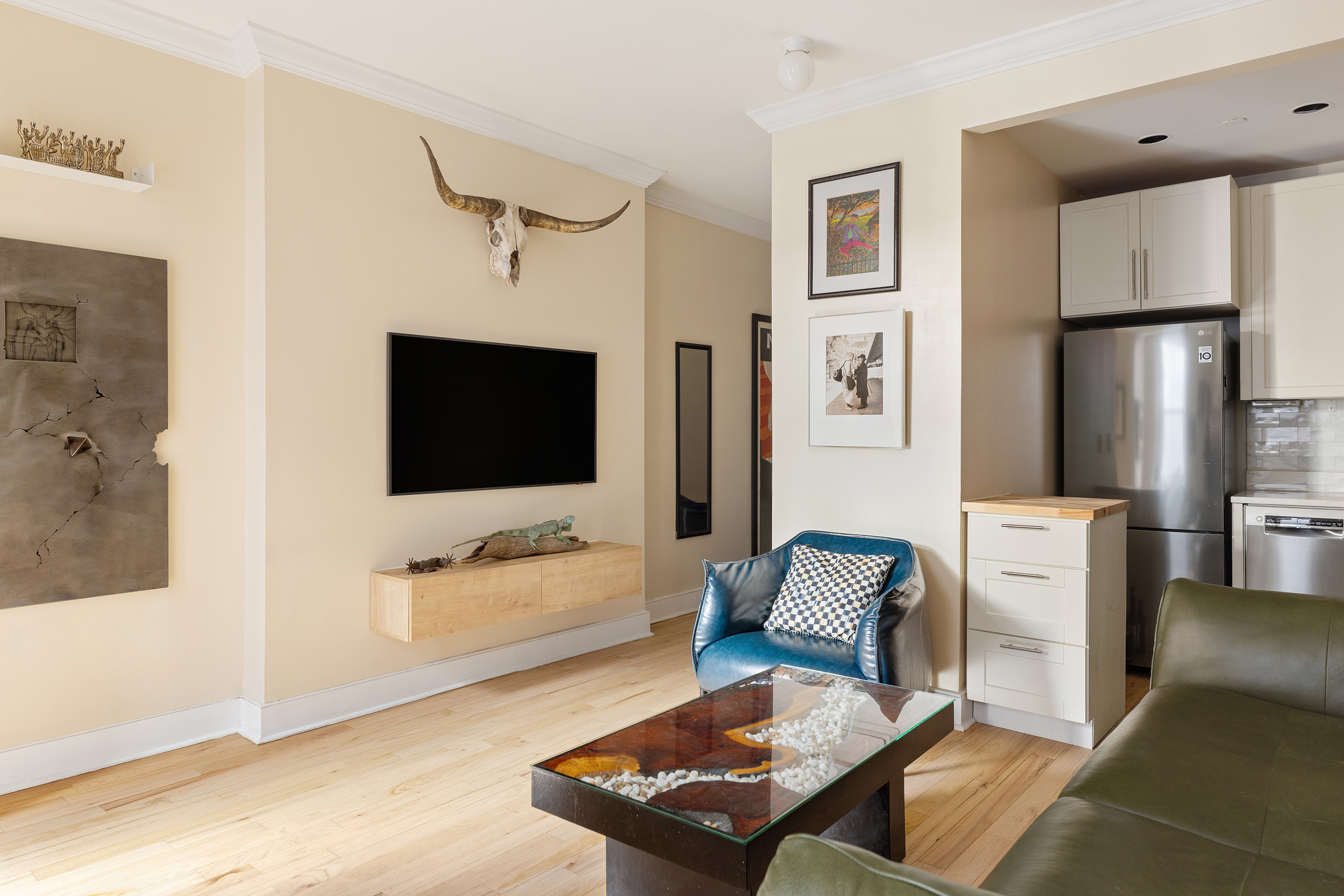 555 Lenox Avenue, Unit 3C Manhattan, NY 10030 - Photo 4 of 7 a living room with furniture and a flat screen tv