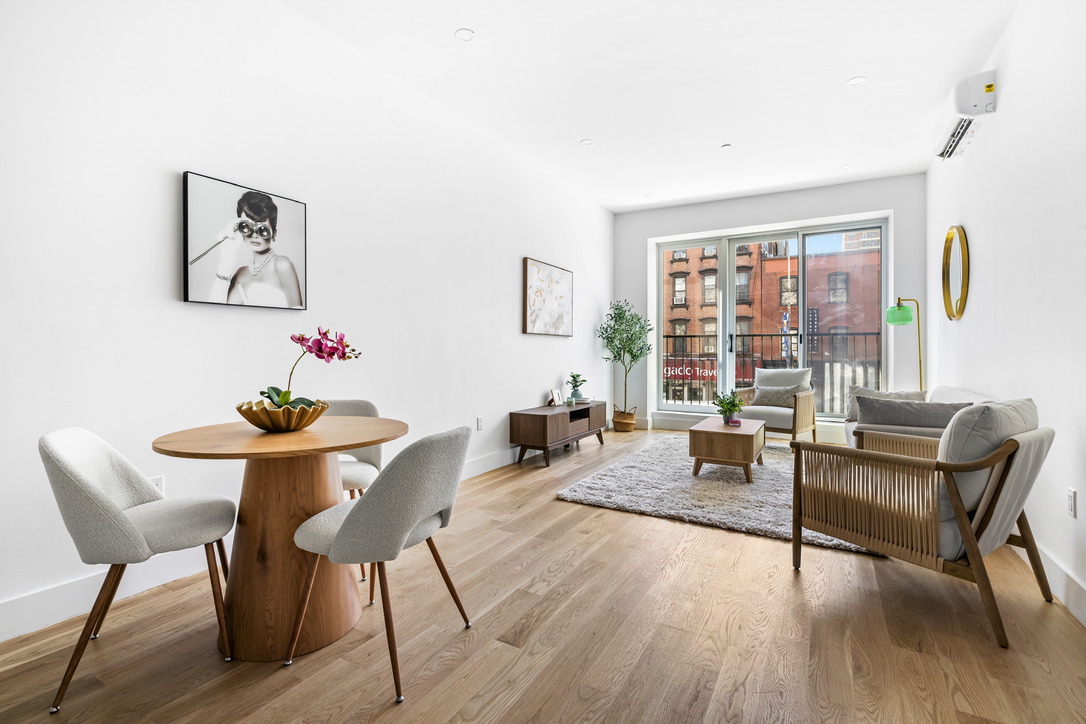 106 Graham Avenue, Unit GARDEN Brooklyn, NY 11206 - Photo 3 of 10 a living room with furniture and a large window