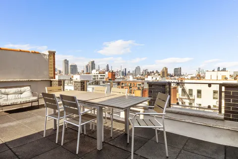 a view of a terrace with furniture and stove