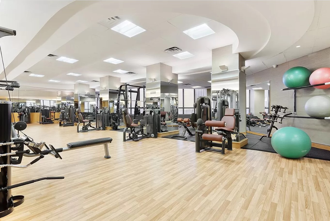 415 East 37th Street, Unit 32G Manhattan, NY 10016 - Photo 11 of 19 a living room with lots of furniture and gym equipment