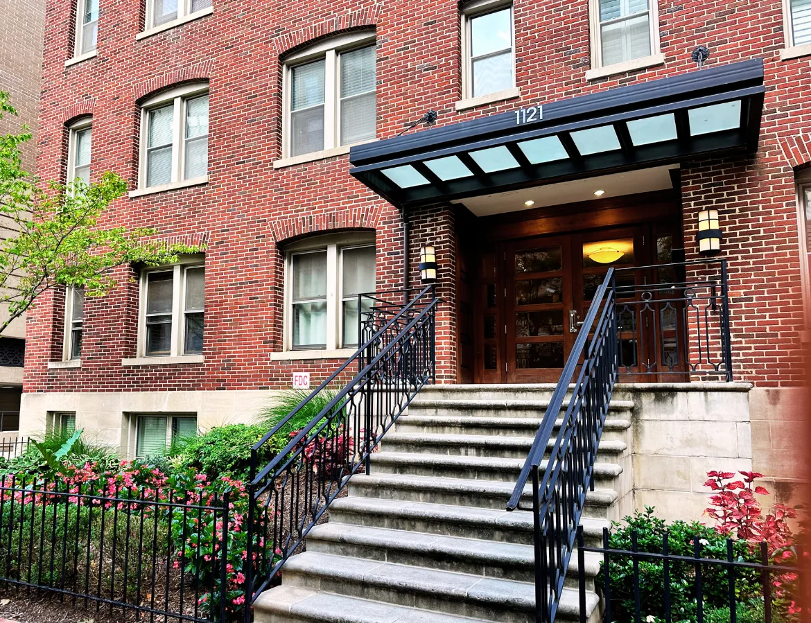 a front view of a multi story building with a yard