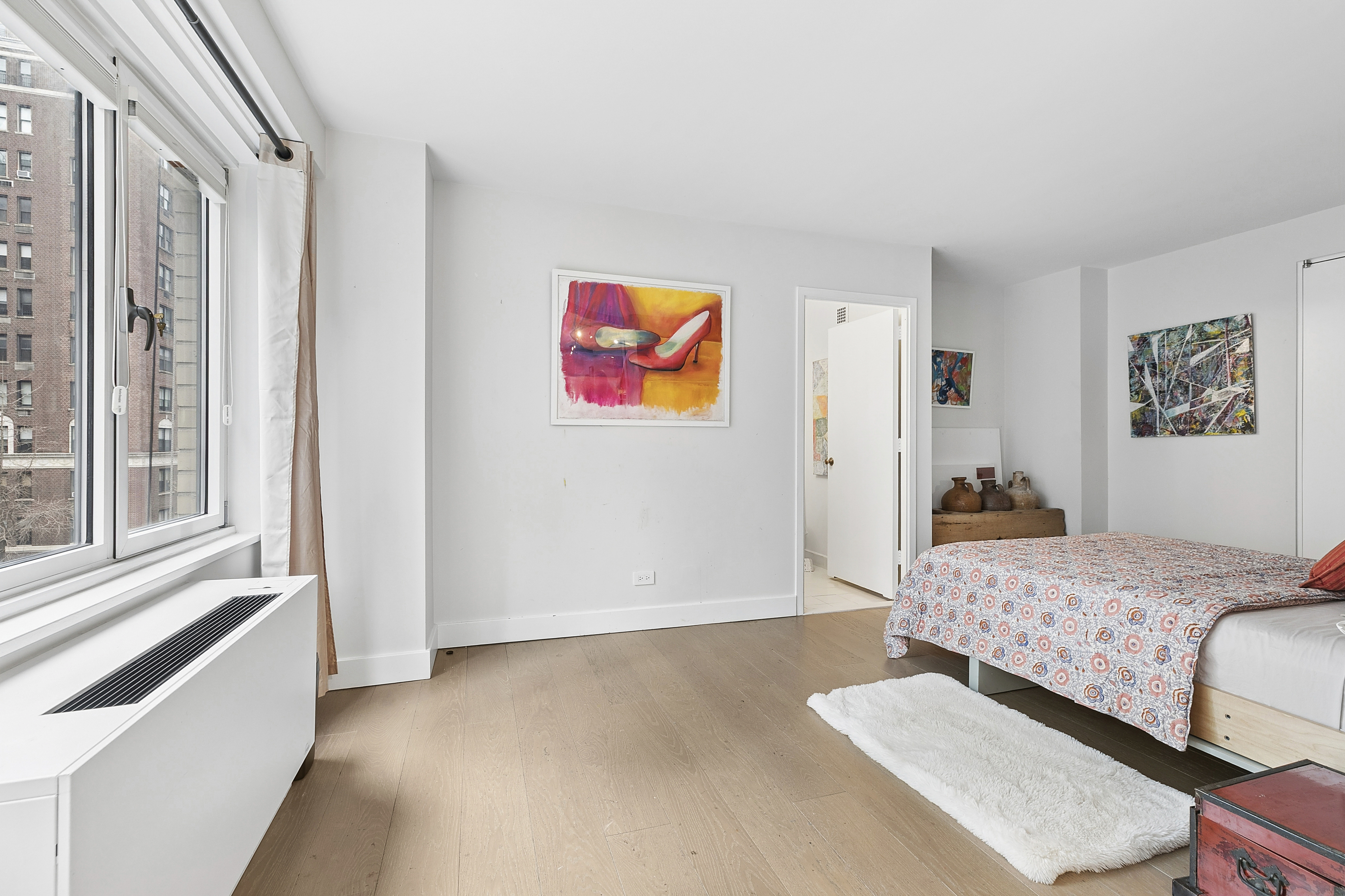 1065 Park Avenue, Unit 4BC Manhattan, NY 10128 - Photo 11 of 16 a bedroom with a bed and a painting on the wall