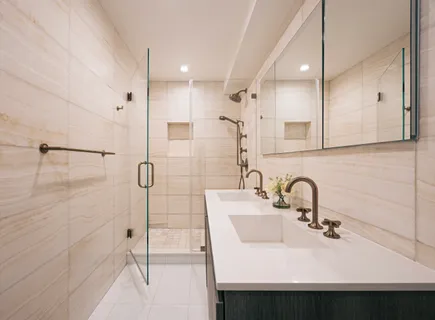 a bathroom with a sink shower and a mirror