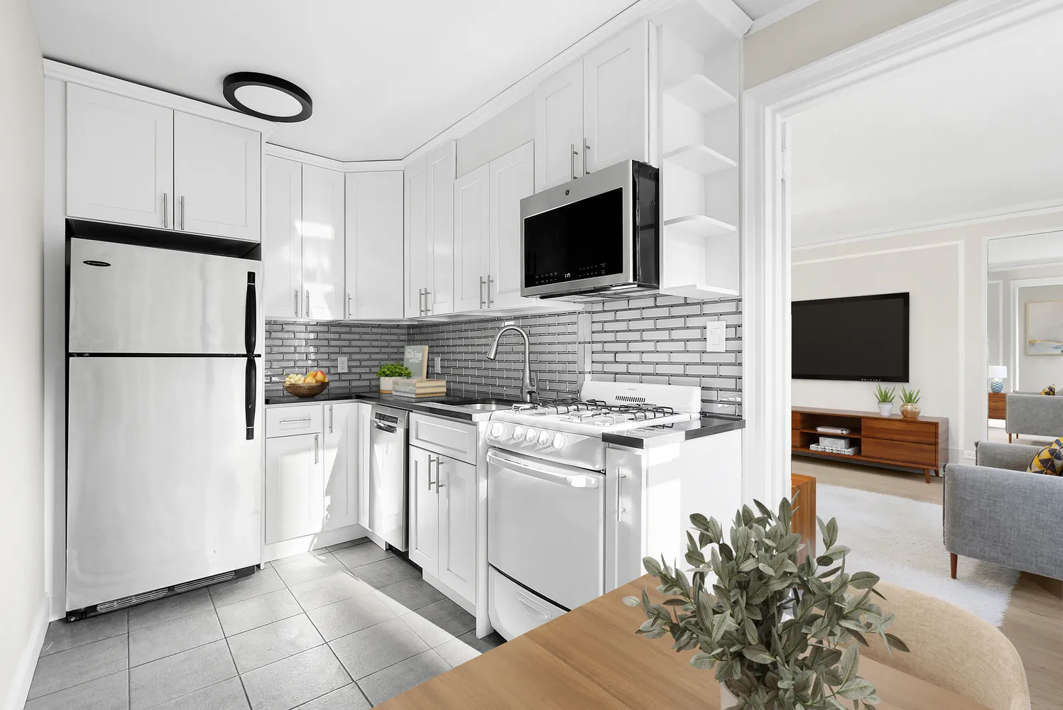 a kitchen with stainless steel appliances a stove microwave and refrigerator