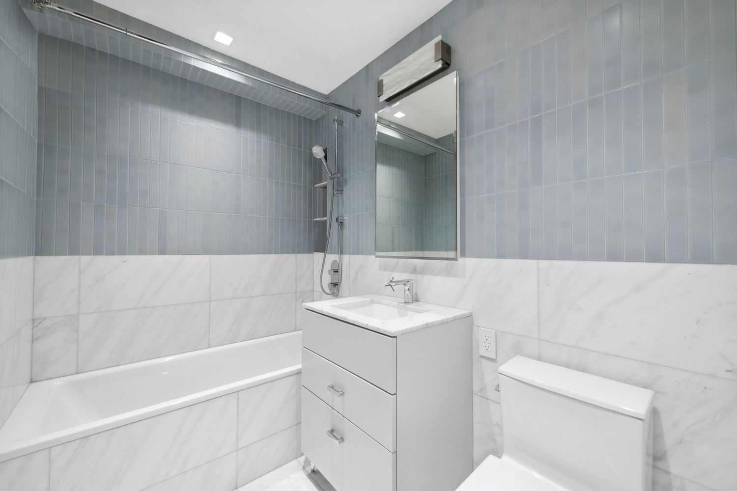 650 Park Avenue, Unit 9B Manhattan, NY 10065 - Photo 10 of 14 a bathroom with a sink toilet vanity and tub
