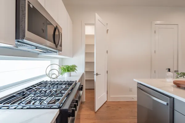 a kitchen with a sink a stove and chairs