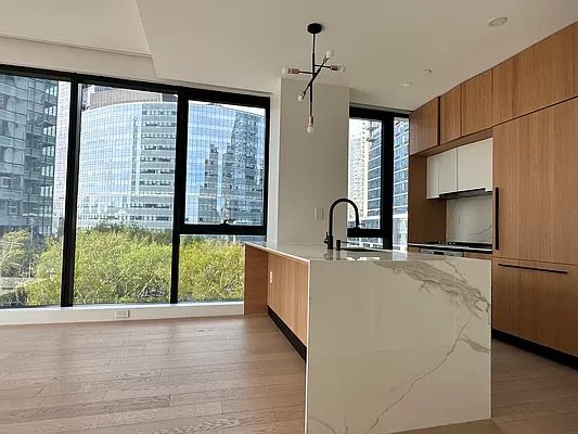 4507 Court Square, Unit 8D Queens, NY 11101 - Photo 24 of 28 a view of a kitchen with a sink and a large window