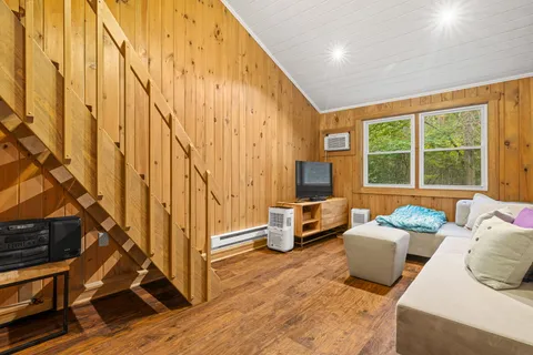 a spacious bedroom with a bed and a chandelier