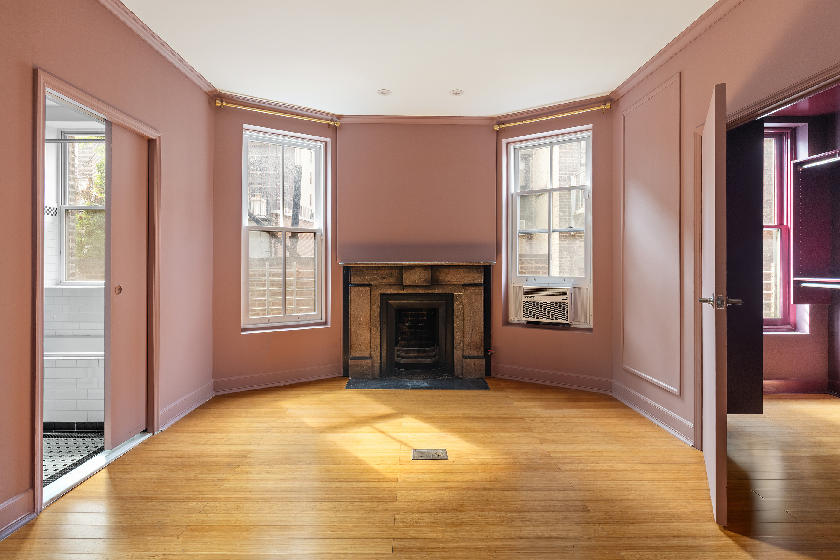 126 East 19th Street Manhattan, NY 10003 - Photo 7 of 13 a view of an empty room with window and fire place