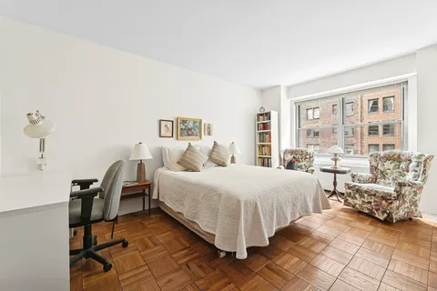 a bedroom with double bed and a large window