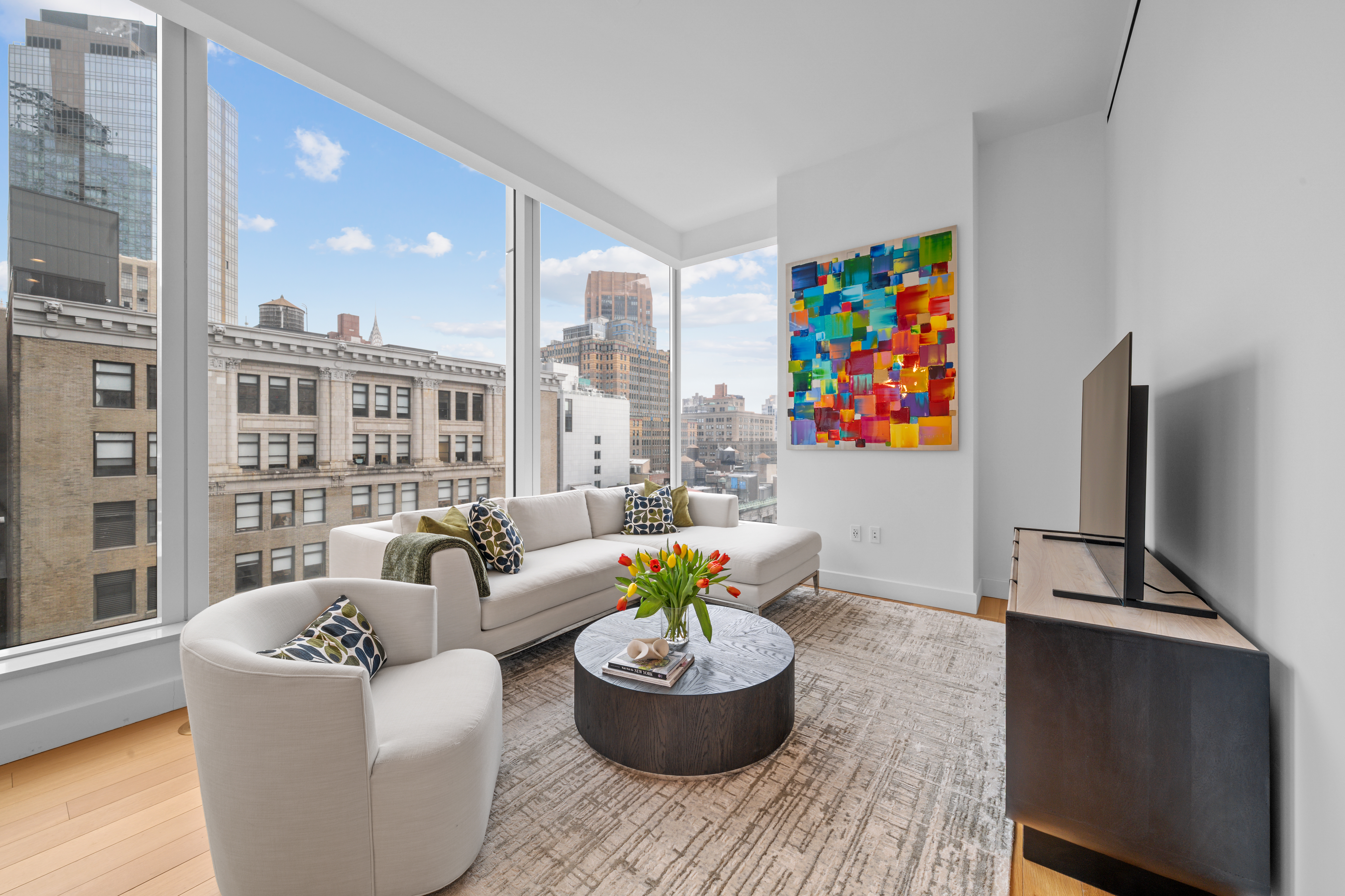 15 East 30th Street, Unit 19B Manhattan, NY 10016 - Photo 12 of 40 a living room with furniture and a potted plant