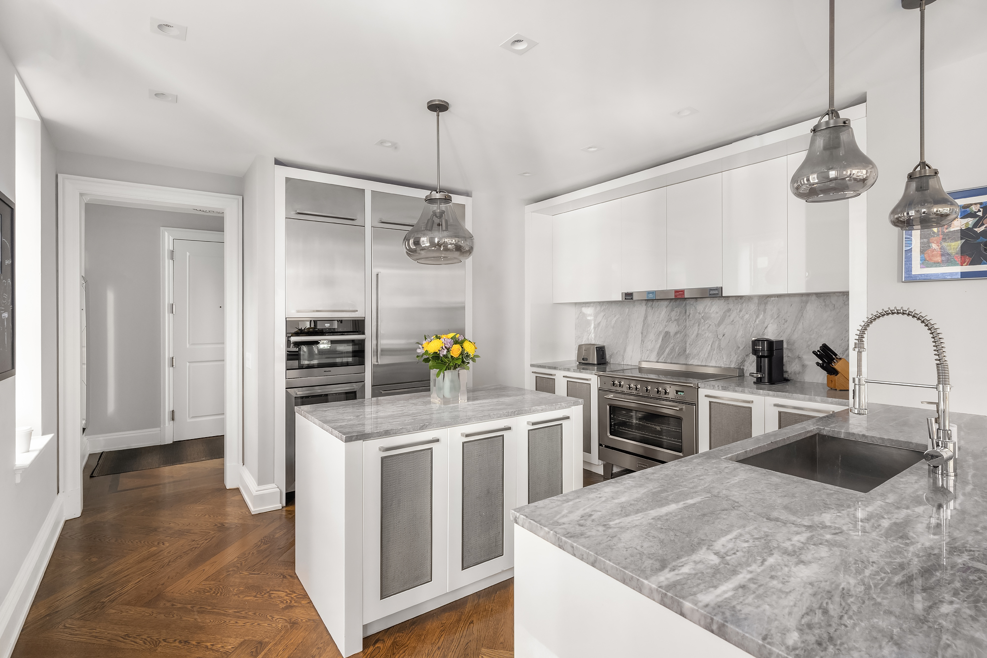 344 West 72nd Street, Unit 1007 Manhattan, NY 10023 - Photo 6 of 23 a kitchen with stainless steel appliances granite countertop a sink a stove and refrigerator