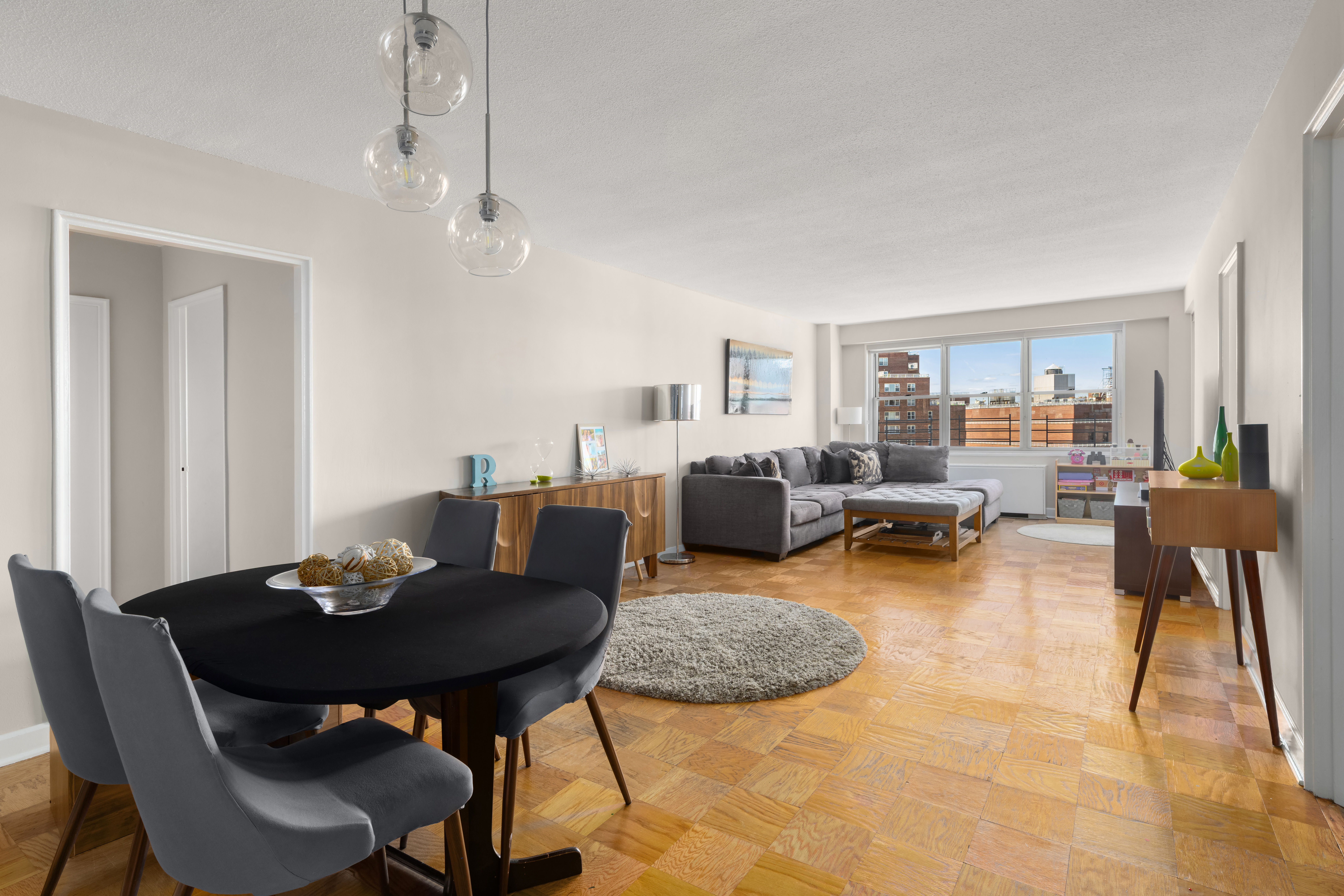70-31 108th Street, Unit 12D Queens, NY 11375 - Photo 1 of 16 a living room with furniture a rug and a window
