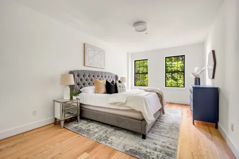 a bedroom with a bed and a window