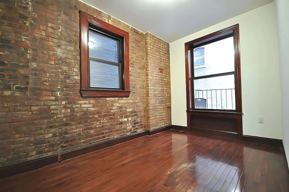 422 Amsterdam Avenue, Unit 3A Manhattan, NY 10024 - Photo 3 of 11 a view of an empty room with wooden floor and a window