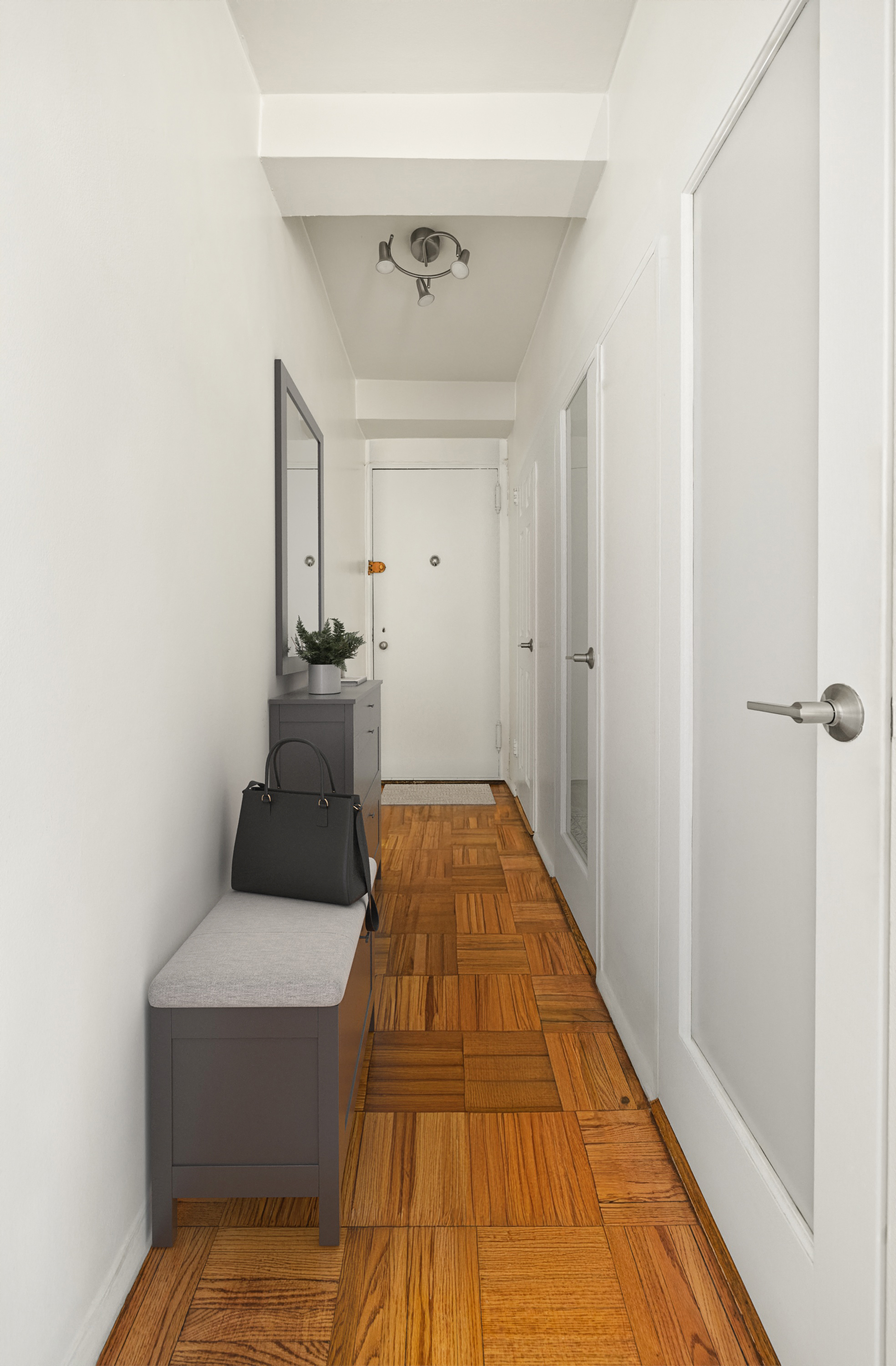 45 West 54th Street, Unit 9E Manhattan, NY 10019 - Photo 8 of 9 a hallway with a bed and a table in it