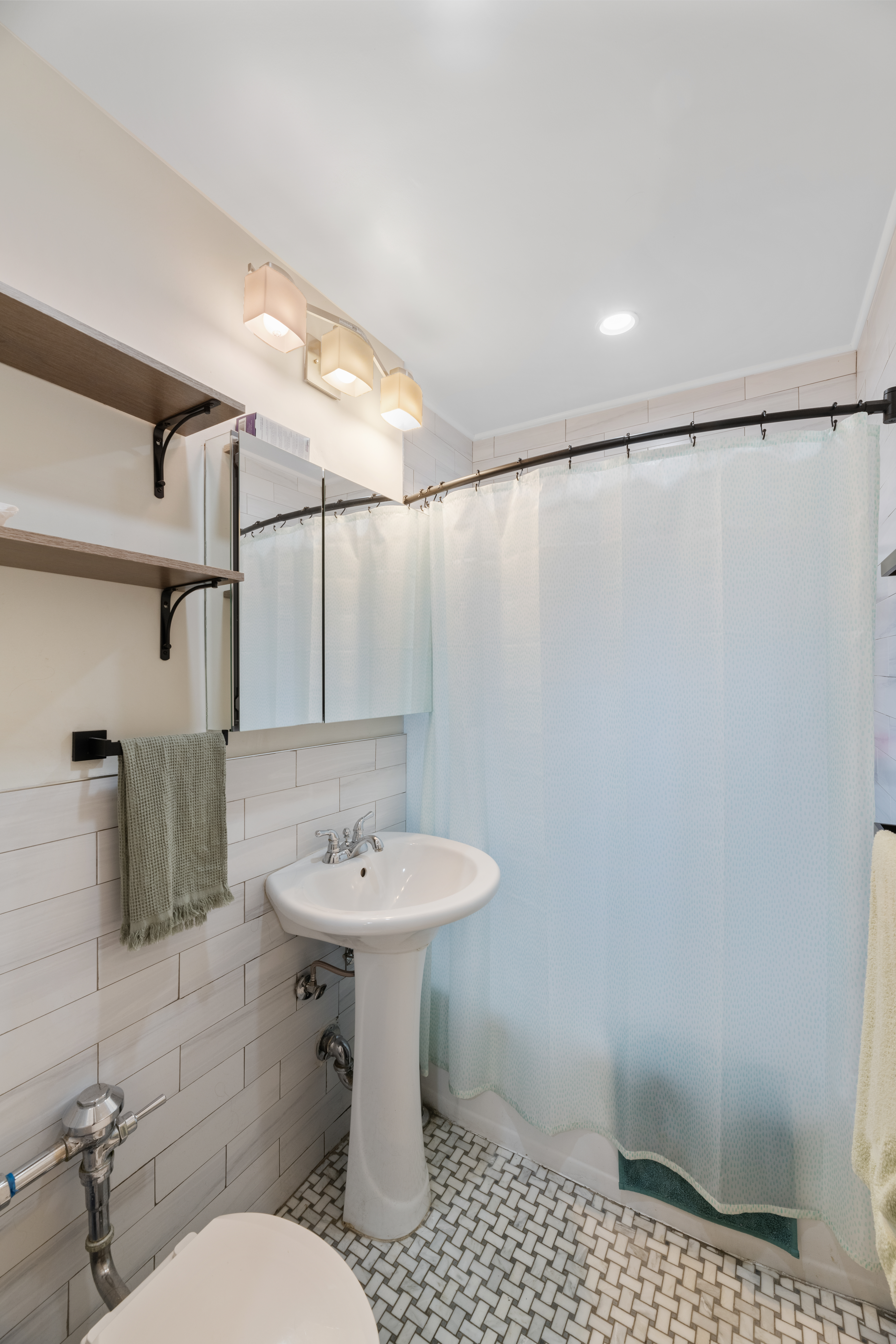 800 Grand Concourse, Unit 5JN Bronx, NY 10451 - Photo 4 of 7 a bathroom with a sink toilet and shower