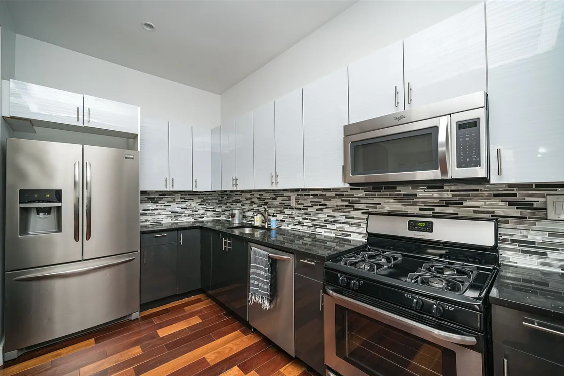 29 Melrose Street, Unit 2 Brooklyn, NY 11206 - Photo 4 of 13 a kitchen with stainless steel appliances and granite countertop a stove top oven