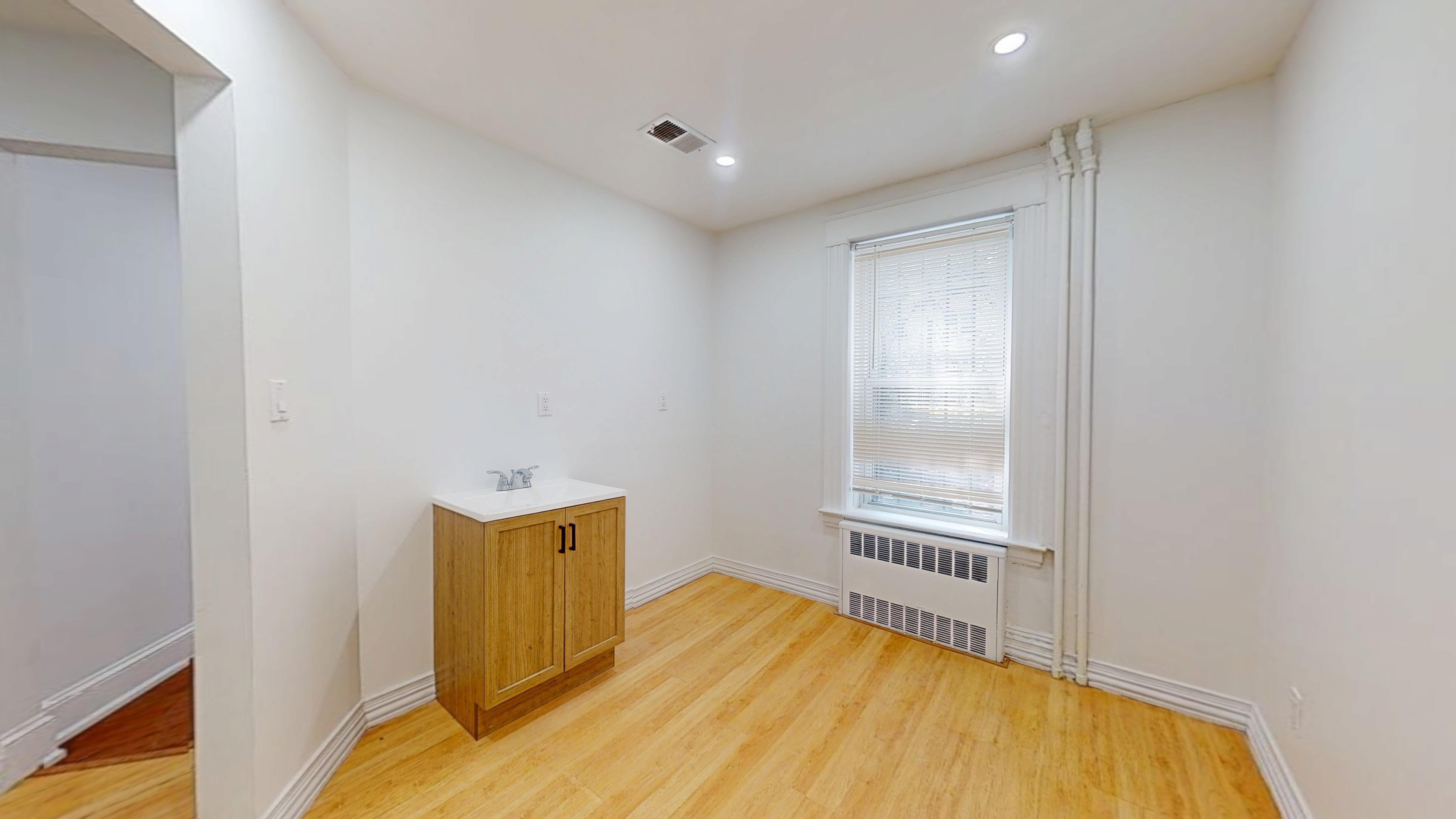 454 77th Street, Unit 1 Brooklyn, NY 11209 - Photo 7 of 10 a view of a room with wooden floor and a window
