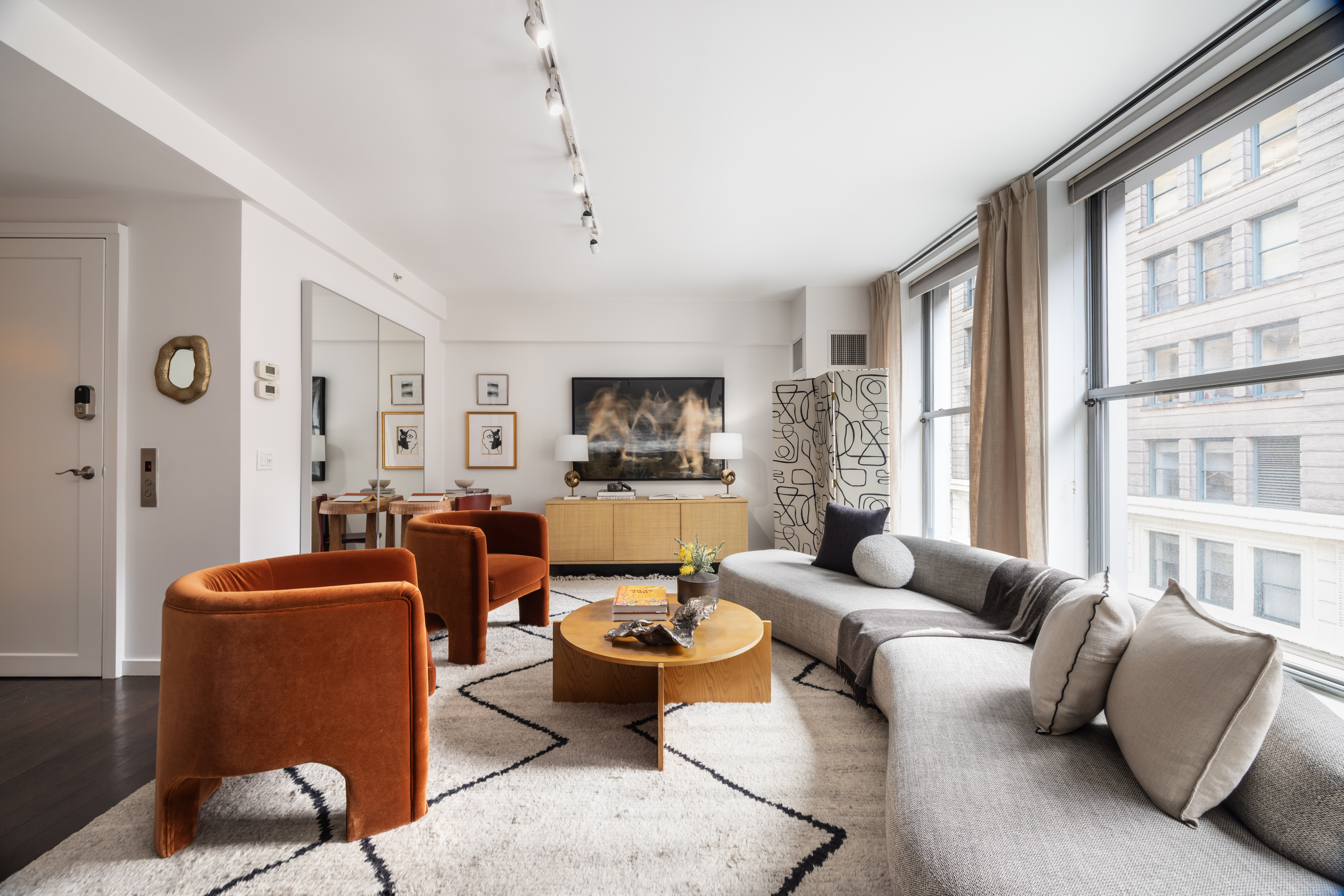 27 West 19th Street, Unit 6 Manhattan, NY 10011 - Photo 2 of 10 a living room with furniture or couch and a large window
