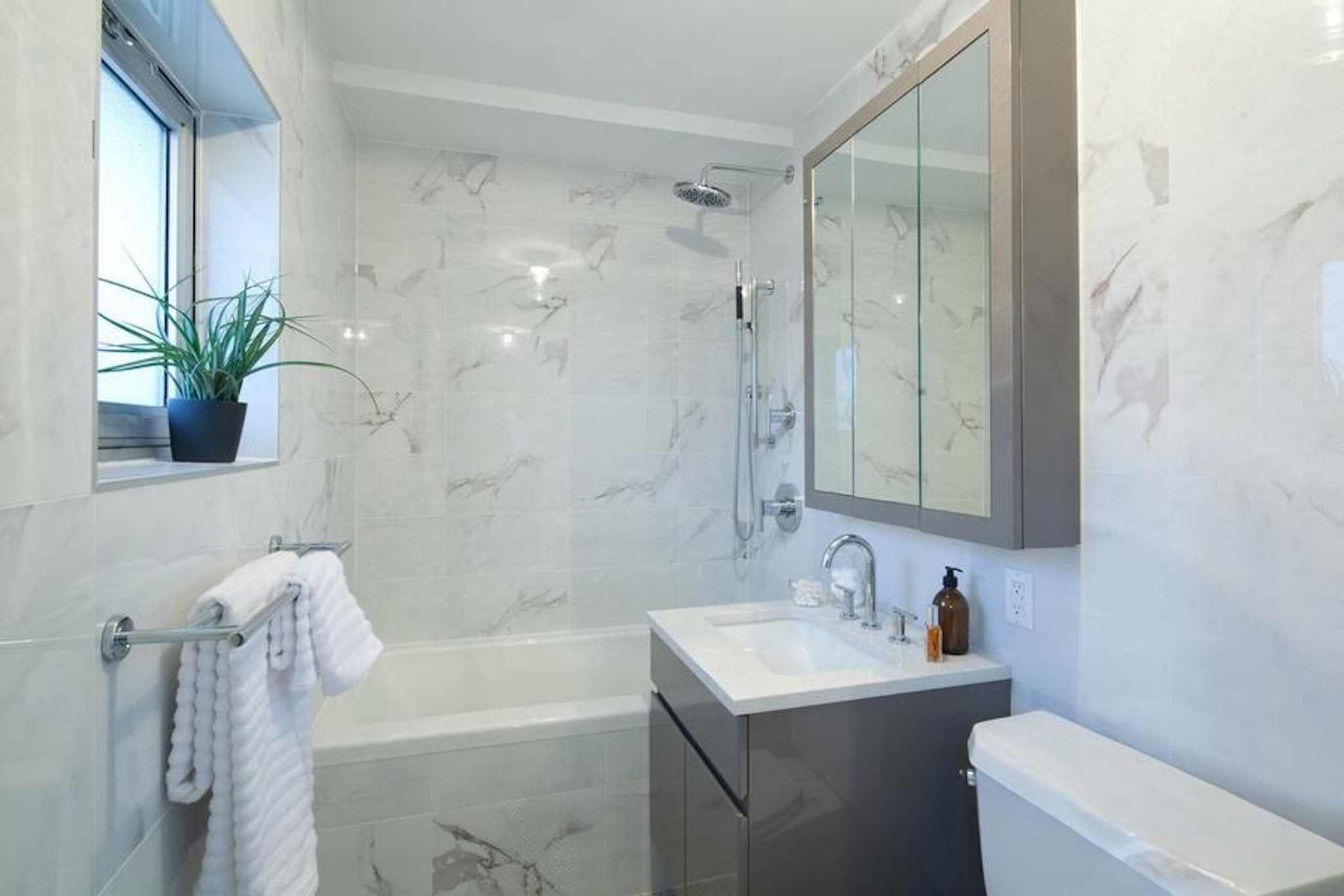 224 Wythe Avenue, Unit 68E Brooklyn, NY 11249 - Photo 6 of 10 a bathroom with a sink a toilet and shower