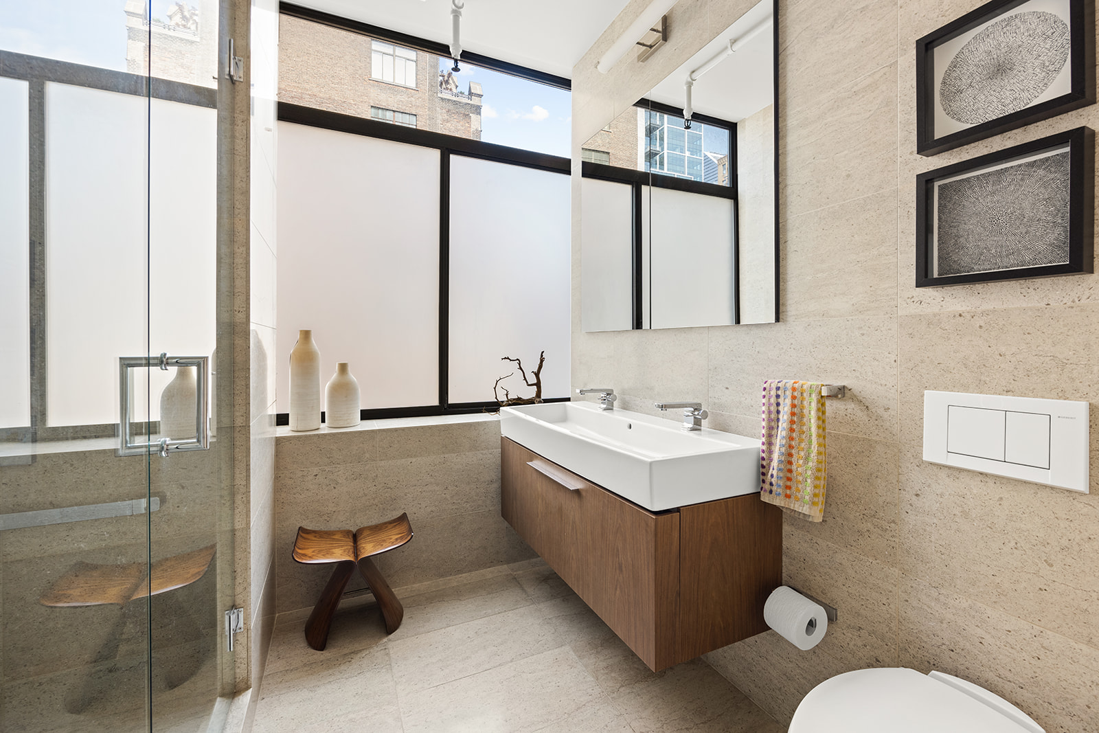 348 West 36th Street, Unit 6N Manhattan, NY 10018 - Photo 6 of 12 a bathroom with a sink mirror and toilet