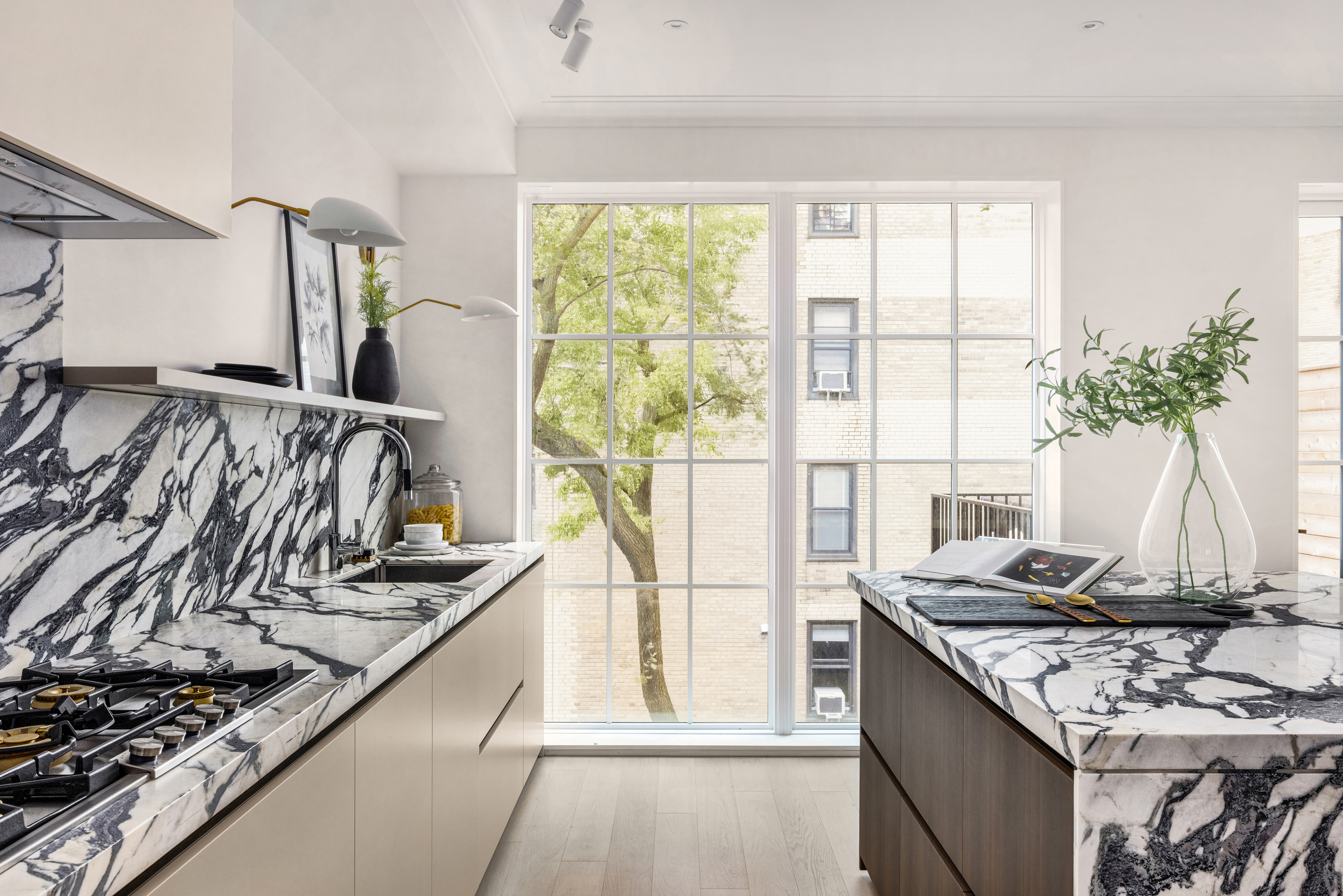 344 West 84th Street, Unit PH Manhattan, NY 10024 - Photo 7 of 19 a kitchen with a stove and a wooden floor