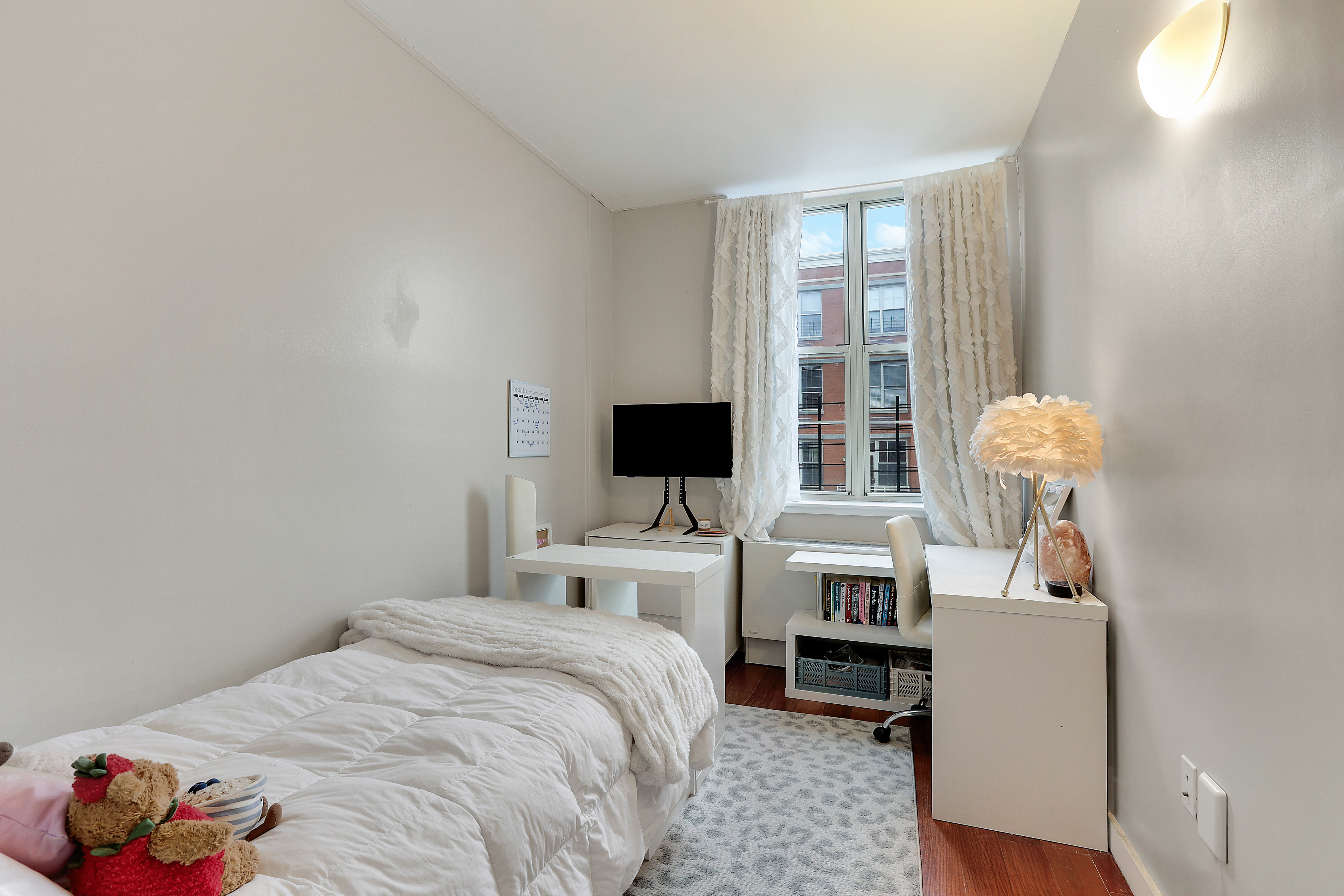 313 West 119th Street, Unit PHE Manhattan, NY 10027 - Photo 9 of 19 a bedroom with a bed and a flat screen tv