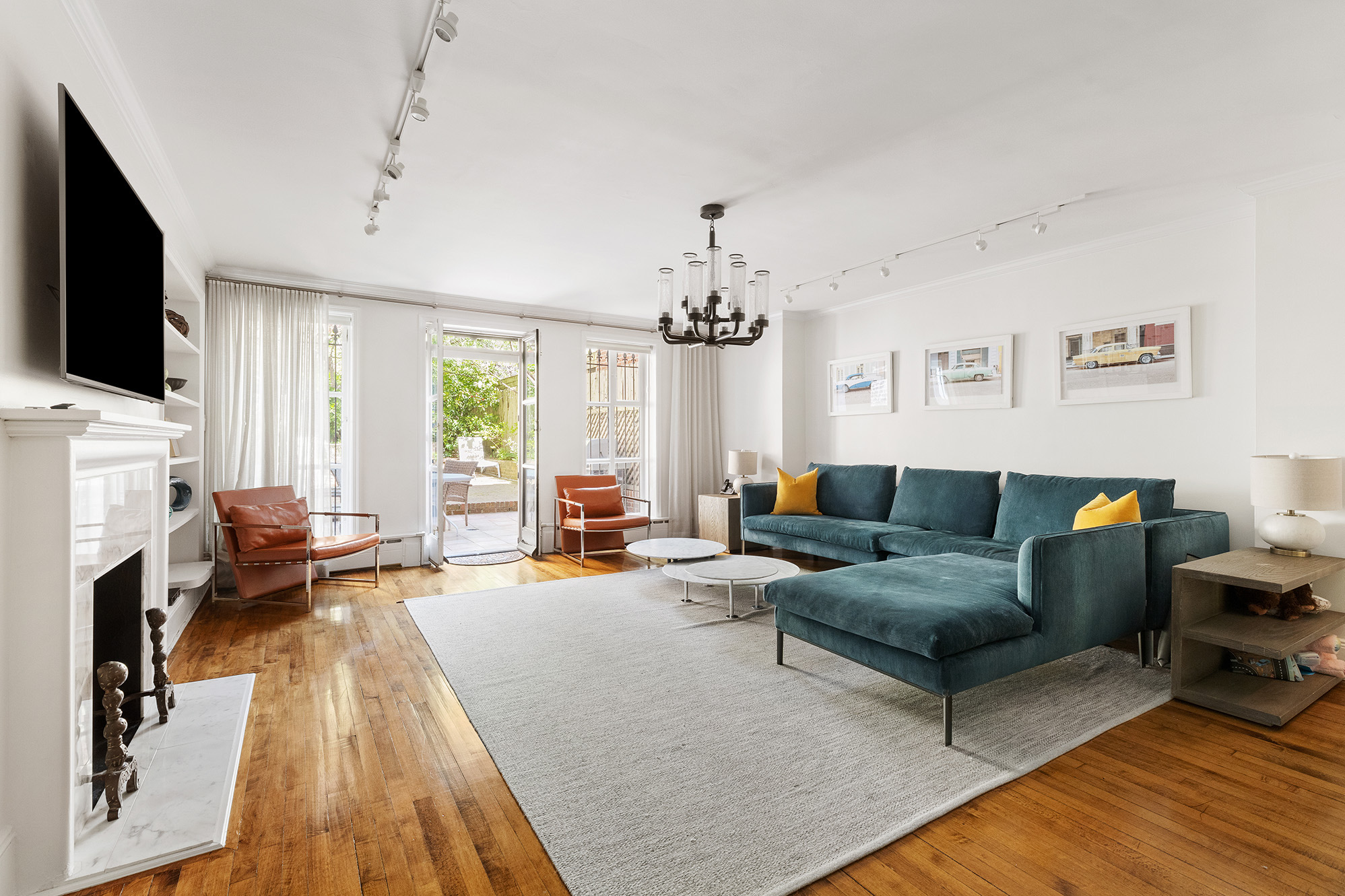 209 East 61st Street Manhattan, NY 10065 - Photo 14 of 24 a living room with fireplace furniture and a flat screen tv