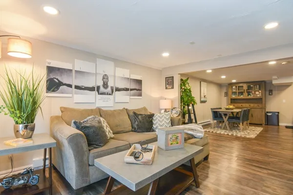 a living room with furniture and wooden floor