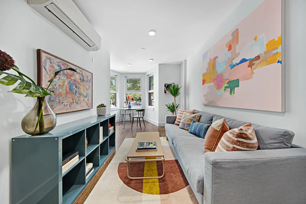 a living room with furniture a couch and wall paintings